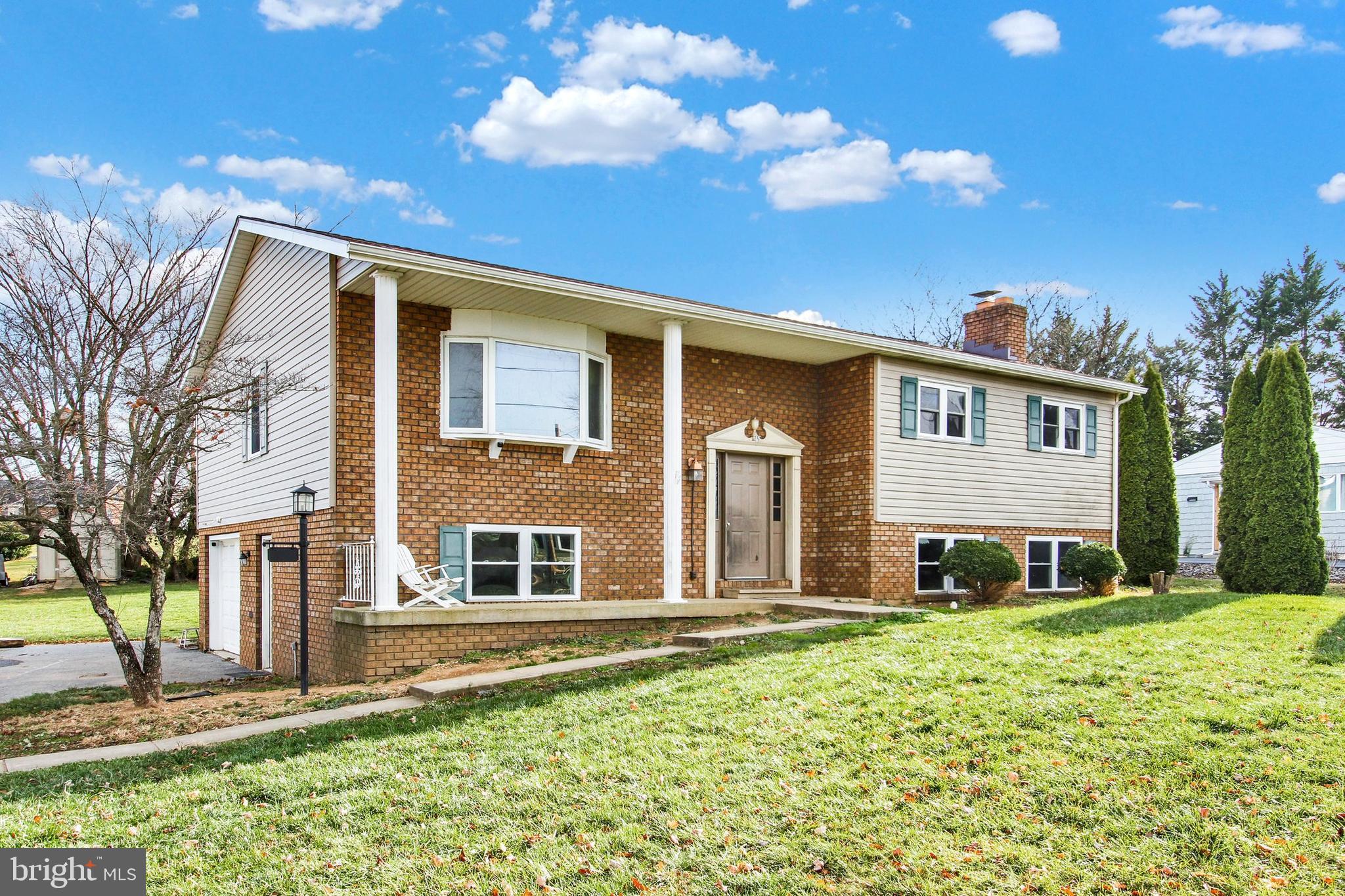 OFFERS RECEIVED, PLEASE SUBMIT HIGHEST AND BEST BY 4:00 PM MONDAY 12/4...WOW, four bedrooms, two and a half bathrooms on almost 1/2 an acre with amazing views in Southwestern school district  under 300K. This home is an excellent location for commuters, just a few miles over the PA/ MD line, super convenient for shopping, restaurants, schools, entertainment, and more. Enjoy plenty of countertop space and a kitchen island while cooking and more than enough cabinet space for storage. Vaulted ceilings in the upper level family room create even more space and add character. Three spacious bedrooms and two full bathrooms on the upper level provide plenty of room for family and friends. 
 Enjoy the gorgeous sunrises from the spacious trex deck overlooking the tree-lined backyard.  Mature trees provide privacy on two sides with amazing country side views on the other side.  A finished lower level with a fourth bedroom  and half bath provide all the space you need for entertaining or a family movie night by the wood stove. Schedule a private tour and start planning your personal touch to make this house your home.