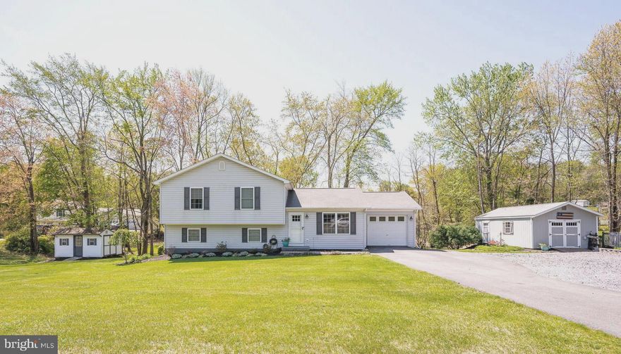 Don't miss out on this nicely remodeled Tri Level Home.  As you pull up you will see the beautiful landscaped yard and the extra parking added, enough room for camper.   When you enter the home you will love the Kitchen/Dining  area which is great for entertaining   Kitchen has been remodeled to include Quartz counter tops, double ovens, gas cook top, lots of cabinets and large kitchen island.  As you head down a few stairs to the lower level you will find the large living room, extra side area for more dining/game playing table or could easily be coverted into an additional bedroom or office.  Laundry room is located in the lower level also with a 3 piece rough in for future bathroom.  This is a walkout level to the rear yard.  If you head upstairs you will find the large master bedroom with walk-in closet and full bath.  Bedroom 2 offers 2 closets.  Bedroom 3 is currently being used as office but also offers a large closet.  The one car garage off the kitchen is drywalled and painted floors and new garage door opener.  Off the kitchen is the deck 16 X 20 with stairs at each end.  Great for grilling and entertaining also!  Property also offer 2 sheds the first one would be great for workshop, has electric.  The second shed has double doors great for storage.  The yard is a spacious half acre lot and ready to enjoy!  Come see for yourself before it's SOLD!