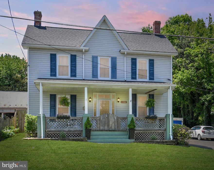 This lovely colonial home nestled on1/4 acre in Monrovia offers a lovely setting, mature trees and beautiful blooming gardens. With Blue Ribbon schools and a location that is serene yet convenient for commuters. Also, enjoy the close proximity to great amenities including restaurants and stores in nearby Urbana.  Relax in the serene fenced rear yard or enjoy sitting on the deck overlooking the garden. The spacious covered front porch is a great spot for having your morning coffee. With five bedrooms and three full bathrooms, you will find plenty of living space.

The main level features a living/family room, kitchen, bedroom, full bath, large walk-in pantry and bonus room–with possible use as a mud room or craft room. The light-filled kitchen features plenty of cabinetry and Stainless Steel appliances. Entertain in the family room–with its unique touch of an under-the-stairs closet–a great spot for storage for games for game night! On the other side of the foyer, you will find a private bedroom with a large closet, built-in shelves and a unique built-in floor-to-ceiling corner cabinet. This room would make a great office, too! On the upper level, there are four large bedrooms. The Primary Suite features an ensuite bathroom, and there is also a hall bath and a convenient laundry center! A full attic with flooring offers extra storage space. With unique and thoughtful touches throughout, this lovely home is ready to welcome you!