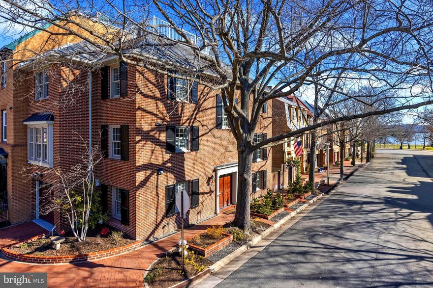 Welcome to this spacious corner brick townhome that embodies the essence of a single-family home with the rarity of 2 exceptional outdoor entertaining spaces, one with Potomac River Views.

This four-bedroom, two full bath and two half bath home is in movein condition and steps to the water, park and trails. Three additional bedrooms plus loft provide flexibility for guests, a home office or a growing family.

Renovated by the esteemed builder, Harry Braswell, just a few years ago, this residence is a testament to his meticulous craftsmanship. The 4th floor loft and rooftop terrace offer privacy and views.

The slate patio off the family room is perfect for entertaining or enjoying a quiet morning coffee. Ascend to the rooftop terrace, and you'll be greeted by sweeping Potomac River views – a breathtaking backdrop for the many firework gatherings in Alexandria.

The thoughtfully redesigned kitchen and family room are open and inviting with entertaining made easy with the large center island.  The laundry room and powder room are also easily assessable.

This home offers the convenience of a garage and off-street parking.  Its located just steps away from the riverfront, the Torpedo Factory, and a short three blocks to King Street. Trader Joe's and an array of recently opened restaurants are all within a few blocks. The location is the best for access to the Southeast and Northeast Quadrants plus no HOA.