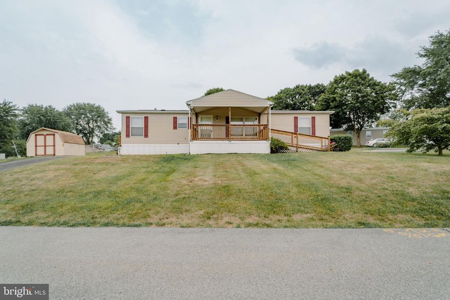 What a rare find in Red Lion, PA.  3 bedrooms and 2 full baths with a covered front porch and access ramp just waiting for you in a quaint 55+ Community.  Exceptionally maintained, this beauty boasts a primary bedroom with primary bath and a gas fireplace in the oversized living room.  Envision yourself on the front porch overlooking the lush green fields and watching the deer inch out of the woods!  Nature abounds.  The convenience of a mudroom w/laundry along with the corner lot, 2 separate parking pads and your own utility shed should be your “icing on the cake”.  What are you waiting for?  Schedule your showing today!