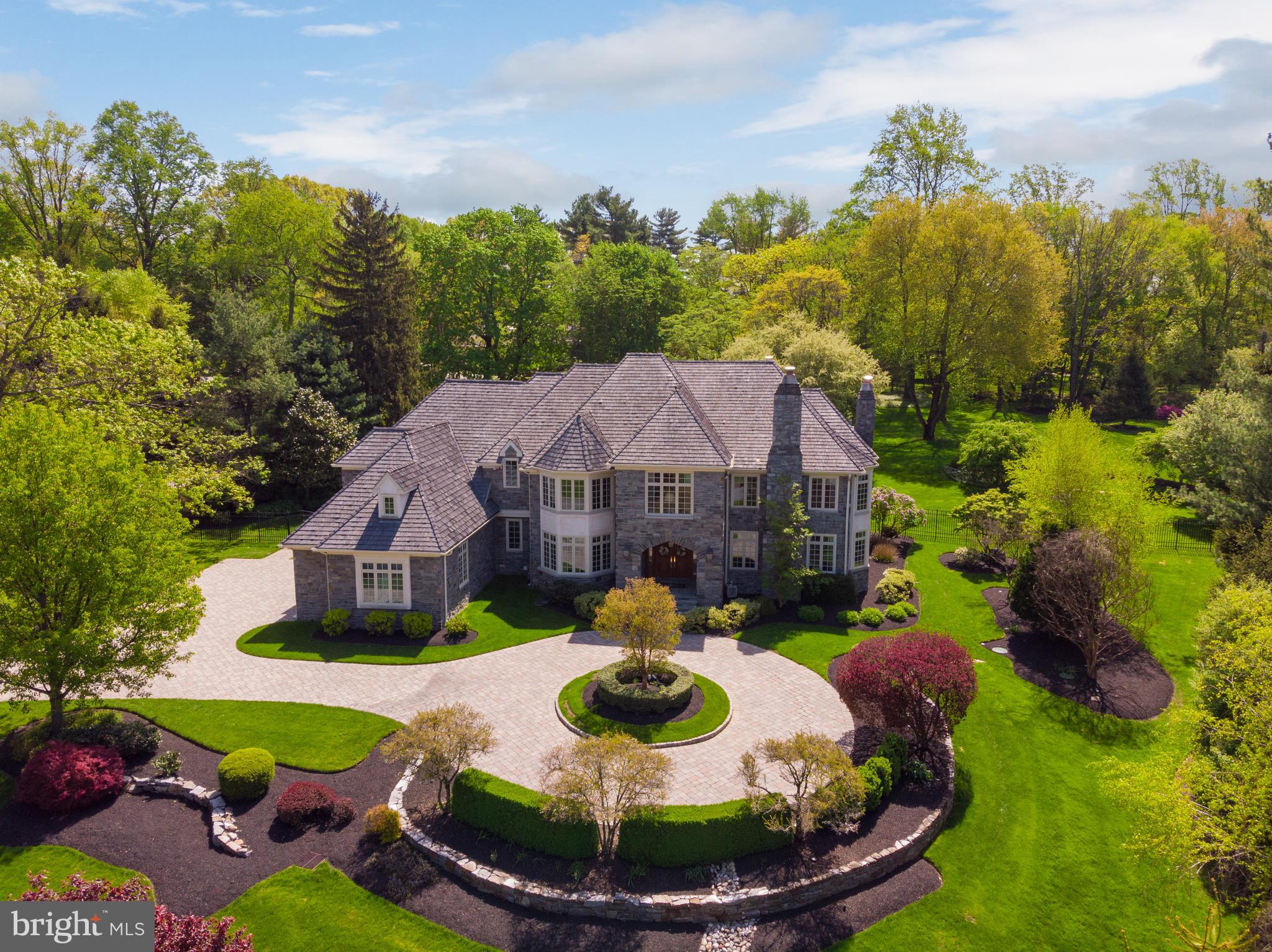 Don't miss this rare opportunity to own the home everyone admires when they pass by, the jewel of the neighborhood, 951 Idlewild Road! This magnificent property in prime Gladwyne, built by C.F. Holloway in 1999, was reinvented by the original owners who added an in-ground pool, purchased & combined the adjacent land, and completely renovated the estate to the highest standards. Boasting an extremely private setting, the remarkable 9,600 sf residence with 6 bedrooms & 7.2 baths now sits on 2.77 fully fenced, lushly landscaped acres. The curb appeal is enhanced by an entire facade of real stone, beautiful paver & circular drive, and added covered porch with automatic screens. The gorgeous interior was meticulously reconfigured into a wonderful open-concept layout, designed for entertaining intimate groups & large parties, with top-of-the-line finishes at every turn. It is truly beyond compare, featuring 5 walnut floors, high-quality custom millwork & cabinetry, Lutron lighting, Sonos music & other fine details throughout. For today s discerning family, there are so many ways to enjoy this awe-inspiring yet comfortable house, whether entertaining friends in the formal living & dining spaces, sitting by the fire in the living room, having coffee in the gourmet kitchen s Miele coffee center, hosting a barbecue on the outdoor patio, reading a book in a quiet corner, or cheering on your favorite team in the fabulous basement. Light pours in from abundant windows on all sides, showcasing lovely property views. Culinary perfection is made in the premium showstopper kitchen that satisfies the most demanding chef, graced by 100+-year-old ceiling beams, custom cabinetry, huge dual islands & state-of-the-art appliances. The sun-bathed breakfast area opens to the rear outdoor patio oasis, and the incredible family room with wood beams, a fireplace flanked by built-in cabinetry with display glass & built-in wet bar. The divine vaulted section of the family room is brightened by skylights, picture windows & French doors also leading outside. Among the many other highlights of this immaculate beauty is a private den, deluxe master suite, graciously-proportioned family/guest bedrooms, spa-quality bath & incredible lower level with a 1000+ bottle wine cellar, exercise room with an adjacent steam shower bath, dog bath plus every amenity for an incomparable lifestyle. The phenomenal fenced-in pool with a patio & relaxing spa provides the ultimate resort-style pleasure.