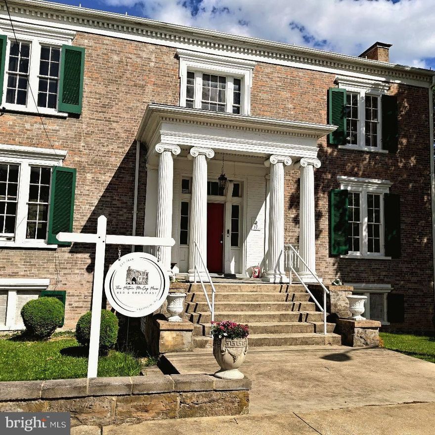 Step into a living piece of history with the iconic Historic McCoy House in the heart of Franklin, Pendleton County.
Built in 1848 for prominent local leader William McCoy, this stately L-shaped Greek Revival home has stood as a cornerstone of the community for over 175 years. William McCoy served as deputy sheriff, justice of the peace, and as a representative of Pendleton County in the state legislature, leaving behind a legacy woven into the very walls of this remarkable property.
Rich in Civil War history, the McCoy House served as a military headquarters and housed a vital telegraph line connecting Franklin to Moorefield — a primary source of communication for troops during the war. Through triumph and tragedy, this home has endured — even surviving the devastating 1924 fire that destroyed much of downtown Franklin. In the aftermath, the McCoy House remained standing and became a place of stability and commerce as the town rebuilt.
Throughout its storied past, the property has served many roles in the community, including housing the Pendleton County Town Offices and the Pendleton County Library. For generations, it has been a place filled with memories for the people of Franklin and beyond.
Today, the Historic McCoy House operates as a charming Bed & Breakfast, offering beautifully appointed staterooms and suites, comfortable amenities, warm meals, and special package options for guests seeking both relaxation and history. The carriage house on the property has an additional bedroom and bathroom. This property is also coming FULLY FURNISHED-making it truly "turn-key" and with new solar panels in placed, it's even energy saving!
This is more than a property — it’s an opportunity to own a thriving business and a treasured landmark with untapped potential. The future of Pendleton County hospitality could begin with you at the Historic McCoy House.