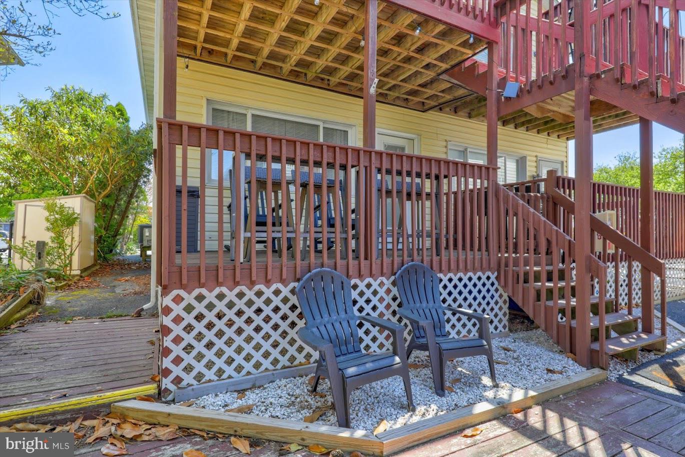 Enjoy the coastal convenience of being located just steps from enjoying both the beach and the bay in this Ocean City condo! This first level condo welcomes you home from a front shared deck that displays beautiful water views. An open and airy interior features a bright and neutral color palette and two sizeable bedrooms and two full baths. The spacious living room encourages gathering and is situated off the updated kitchen with new stainless appliances, painted cabinetry, breakfast island, and dining area. The generous primary suite hosts an attached full bath and invites in elegant streams of daylight. Sip your morning coffee or enjoy the evening sunsets over the water on your personal front deck as whispering summer breezes come off the bay. This condo is perfect for a full-time residence or beach getaway! Located near downtown Ocean City, you are steps from everything coastal living has to offer. Jolly Roger Amusement park is less than a block away along with many other opportunities for entertainment, dining, and shopping. Daily strolls on the Ocean City boardwalk are easy when you live directly across Coastal Highway from the North end!