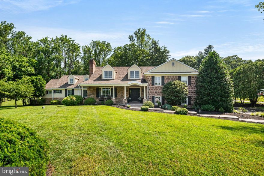 Welcome to 2895 Gradyville Rd, a stately 5 bedroom, 3 full, 2 half bath brick and stone colonial set on nearly an acre of beautifully landscaped grounds in Broomall. This home offers timeless architecture, thoughtfully designed living spaces, and a backyard retreat that feels like your own private sanctuary. From the moment you arrive, you are greeted by a charming front porch that invites you to sit a while and enjoy your morning coffee. Step inside to the two-story foyer, where natural light pours in from the window above, illuminating the elegant chandelier and newly refinished hardwood floors. To your left, a formal dining room with a cozy fireplace sets the stage for memorable gatherings. Just beyond, a charming sitting room connects to the kitchen and second dining area. The kitchen is a dream to cook in, featuring a 10-burner Wolf stove, a Sub-Zero refrigerator, a wine fridge, warming drawer, plenty of prep space, and a breakfast island with seating. Just a few steps down from the kitchen is a cozy office with a wood-burning fireplace, laundry room, and half bath. Adjacent to the kitchen is a spacious family room with views of the backyard and sliding doors that open to the patio, blending indoor and outdoor living seamlessly. The first-floor primary suite is a true retreat, complete with two walk-in closets and a spa-like ensuite bath featuring a soaking tub, walk-in shower, and large dual sink marble top vanity. The second floor is spacious with three more bedrooms, one of which has an attached full bath. A full hall bath services the other bedrooms. On the third floor is another private bedroom and additional storage. Step out back to one of the most serene and functional backyards you’ll find. The private retreat includes a stamped concrete patio with a gorgeous surrounding stone retaining wall and a built-in grill with a countertop perfect for hosting summer dinners or relaxing in the shade. A fire pit area invites cozy evenings under the stars, while steps lead to a large fenced-in grassy yard, ideal for play, pets, or peaceful lounging. Electric and water lines are already in place, ready for your dream pool and pool house to be added! Some additional features to this completely renovated home include new windows, brand new washer and newer dryer, 3-zone HVAC system, attached 2-car garage, cedar storage in the basement, large detached shed for outdoor storage and a drywalled basement with plumbing to add a bathroom just ready to be finished for additional living space. Located in the Marple Newtown School District and close to parks, shopping, and major roadways. A rare opportunity to own this stunning home that has been lived in and lovingly updated and maintained by a few generations for the last 60 years.