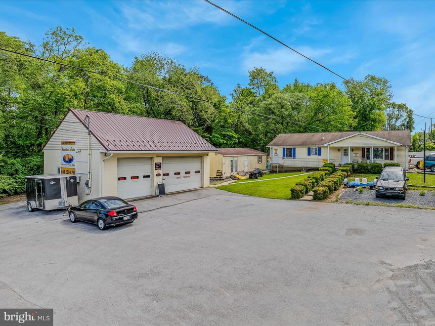 This property provides a great business opportunity. Presently a car dealership and Title and  Tag business, it has tons of potential uses! Great location for an auto repair shop.. You could use it solely for business, or combine business and residential.  Talk about a short commute to the office! The office building features a large, covered front porch. Inside you have a spacious front room for reception and waiting area. Beyond the reception area you have a spacious break room with a wet bar. On this side of the house there are two large, carpeted office and a huge conference room measuring 18 x 13. On the right side of the property you have 2 full baths and a large laundry room with plenty of space for extra storage. And if that's not enough there is a huge 12 ft x 5 ft room for even more storage space! Beyond that you have two more carpeted offices, (or bedrooms). Outside the house you have an 800 sq ft storage shed with bonus room that is heated. Beyond this is the 1050 sq ft commercial garage. It includes a 4 post 12,000 pound lift and a 2 post 8,000 pound lift, along with a commercial air compressor. Outside you have a huge paved parking lot. This property sits at a stoplight at a busy intersection in a commercial/industrial area of Martinsburg - at the intersection of Mid Atlantic Parkway and Williamsport Pike. The tire changer and wheel balance machines are negotiable. This property is the one you've been looking for to get your business going. Schedule your showing today!