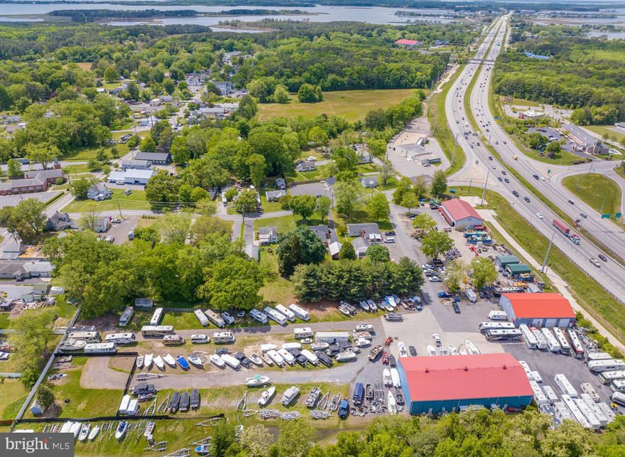 Prime commercial opportunity available just off Route 50 with easy access. This high-visibility location offers exceptional exposure to heavy traffic, making it perfect for businesses looking to attract attention. Close proximity to the Chesapeake Bay Bridge, with prominent digital signage visible to approximately 74,000+ cars per day.   Zoning: The property 5.41 acres is zoned Urban Commercial (UC).  Zoning offers broad uses for the property, including most retail and light industrial.  Tenancy: The site is leased to 2 tenants that utilize the buildings and open-air storage. There is additional rental income for parking utilized by the neighbor (Rental Works). There is a vacant portion of the site that has rental income potential (Discussed in previous years as a cell tower base). Improvements:  The larger building is 130' x 60' which includes a 30' x 60' office area, a 30' x 60' storage area and a 70' x 60' shop area which totals 7,800+/- SF. The smaller building is 80' x 50' on the first floor and 50' x 20' 5" on the second floor for offices which totals 5,025+/-SF. Therefore, the total is 15,600 sq ft.  Both buildings are steel and have mezzanine levels which makes the usable square footage more than the footprint. Utilities: The property is served by public sewer, and the water is provided by a well. Heat is a mixture of oil furnaces running both industrial heaters and heated flooring in the warehouse areas. The office and retail areas are served by HVAC systems.  Check with Queen Anne s County planning and zoning for permitted uses.  Great opportunity.  Call today for showing!