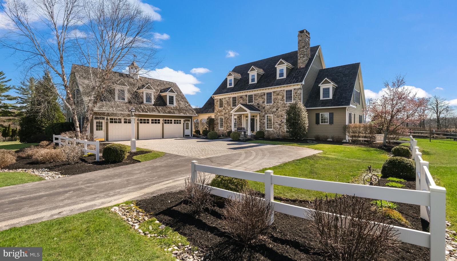 If you're looking for quality and craftsmanship in a serene and private setting, look no further! No detail has been overlooked in this beautiful reproduction farmhouse, from the extensive millwork and built-in's, to the gleaming random-width oak flooring, to the custom pool with exquisite gardens surrounding the property. As you enter down the long driveway, you are met with a beautiful stone courtyard and the detached 3 car garage with an elegant, blue stone lined breezeway connecting this space to the main house. Once inside the front door, the large foyer is flanked by a generously sized dining room and living room with fireplace surrounded by custom built-in's with glass doors. Continuing through the foyer leads you to the 2-story family room with another fireplace with raised hearth, and a wall of windows overlooking the private backyard. Adjacent to the family room is a large breakfast area with vaulted ceiling, skylights, and french doors to the bluestone patio. The adjacent kitchen features inset cabinetry, granite countertops, Wolf and Sub-zero appliances, wine fridge, and a Shaw porcelain sink. The first of 2 laundry rooms in the home is adjacent to the kitchen and allows for easy access to the breezeway connecting the detached garage. The elegant master bedroom on the main level includes a sitting area with vaulted ceiling and french doors to the bluestone patio. The attached master bath features a steam shower and large walk-in closet with custom built-in's. On the second level you will find three generously sized bedrooms, one with with en-suite, and 2 that share a jack-and-jill bathroom. Completing this level is an office with vaulted ceiling and a (second) large laundry room with extensive storage.. The 3rd floor offers a additional finished space with full bath, cedar closet, and kitchenette. On the lower level you'll find an elegant family room highlighted by the 3rd fireplace, again surrounded by custom built-in's, as well as a movie area, gym room, and custom-built bar to satisfy all of your entertaining needs!
Above the extra large, 3-car garage is 1200 square feet of finished space that could have so many different uses! This space features wide-planked pine flooring, a full bath, and a kitchenette.
The pool is well situated on the property to offer easy access from the house while also providing privacy and long distance views. The beautifully designed storage shed is convenient for storage of patio furniture and other pool accessories.
The home offers a whole house generator and interior fire sprinkler system that provide peace of mind as well as a holiday light switch to simplify decorating! All of this AND Council Rock North schools!
This is a very special home - don't miss your opportunity!
