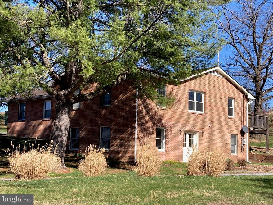 Brick Rancher with Guest Apartment & Scenic Country Views
Nestled in a peaceful country setting and surrounded by large tracts of  farmland, this spacious brick rancher offers privacy, open views, and timeless appeal. The well-proportioned single-level layout provides comfortable living with a seamless connection to the surrounding landscape.

A detached garage with a one-bedroom apartment offers exceptional flexibility—perfect for guests, multigenerational living, or a private retreat. Enjoy tranquil mornings, wide-open skies, and the sense of space that only a true rural setting can provide.

An ideal property for those seeking privacy, versatility, and classic construction in a serene countryside location.

CaCapon River access is close by.    The little town of Capon Bridge has plenty to offer.   The River House is a coffee and delightful lite fare with live music venue.  It also offers outdoor concerts in the summer,  community jams, arts and crafts for the kids, open mic night, poetry, etc...  The Farmer's Daughter which is a farm to table butcher who also offers amazing lunches, several locally run restaurants such as El Puente, Bent River Trading Post for local handcrafted wares, farmer's market in the summer.   Library, churches, post office, etc... The middle and elementary schools are located in Capon Bridge.