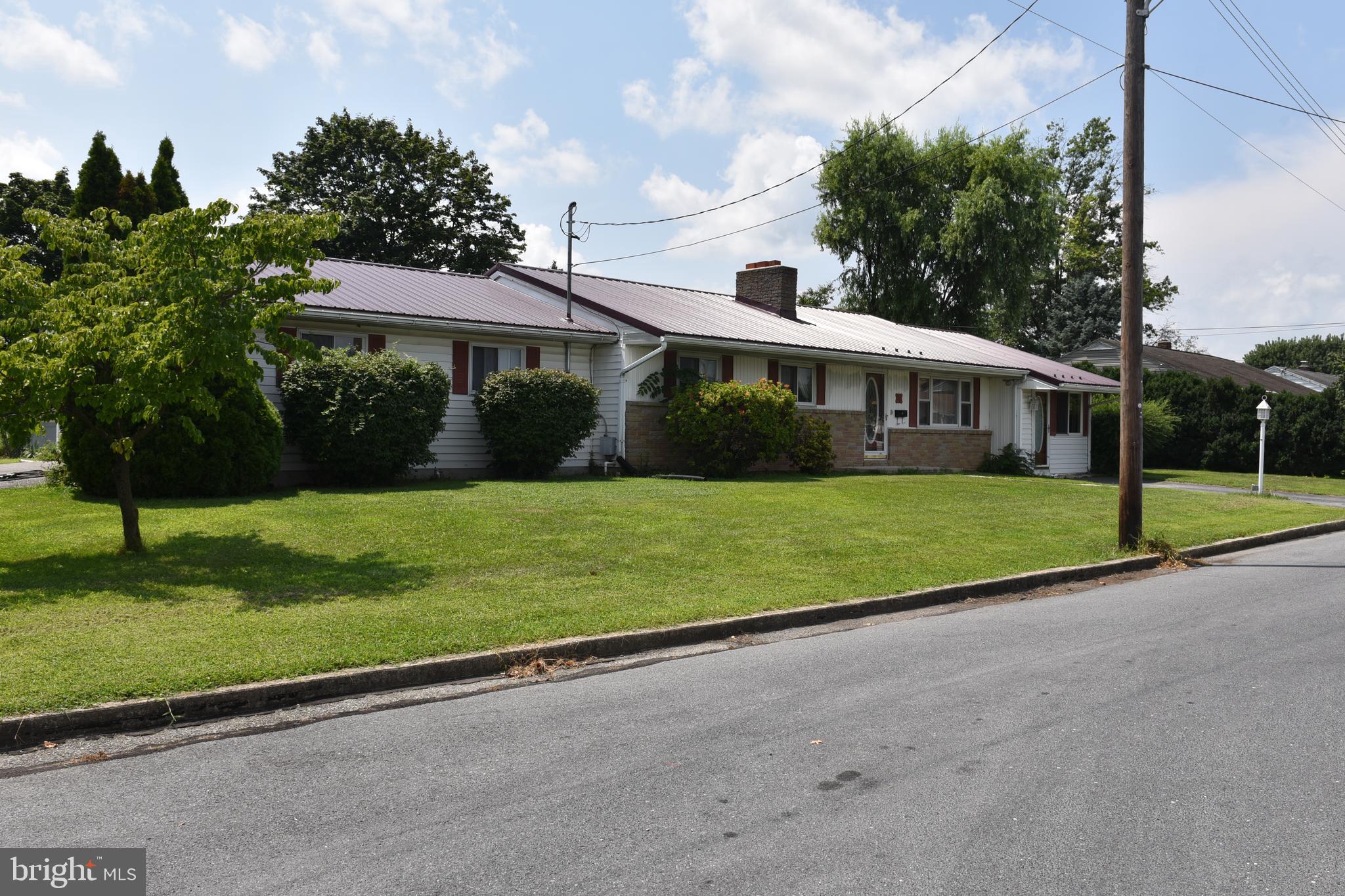 2100 sq foot rancher with large, vaulted living room, separate dining room that leads out to a covered porch and fenced in back yard, nice updated easy to use kitchen, additional office/bedroom, gas fireplace in formal living room, finished basement with 2nd fireplace, central AC, newer windows, new metal roof in 2023, 2 car garage. This home is nice and roomy and accessible to town.
