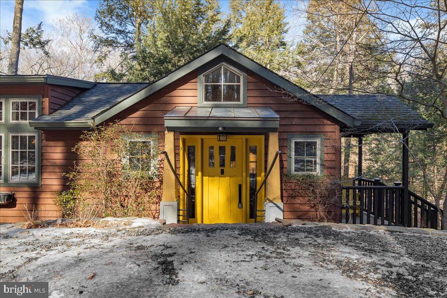 Welcome to your private Tinicum retreat at 14 Ledge Lane. Perched above scenic Smithtown Creek, this cedar-sided Craftsman cottage seamlessly marries historical charm with modern conveniences. The current owners have revitalized the home with a new septic system, professional exterior painting, and upgraded heating and professional landscaping. This 1,774 sq. ft. abode boasts 3 bedrooms and 1.5 baths, with Arts & Crafts details throughout. The chef's kitchen features high-end stainless steel appliances, granite counters, and a spacious island, perfect for entertaining.

Relax in the great room, warmed by a stone fireplace, or step onto the wrap-around deck to soak in the tranquil creek views. The master en-suite offers a Japanese-influenced bath with a soaking tub, while the hot tub on the deck promises relaxation under the stars. Additional amenities include a 2015 cedar-sided carriage house/garage, two newer sheds, and a room above the carriage garage that's been finished for entertainment/recreation.
Nestled on 1.85 acres, with stairs leading down to the creek, this home offers privacy and breathtaking water views. Enjoy modern comforts with built in custom closets and well thought out storage. Experience the best of both worlds in this enchanting Pipersville haven! Within walking distance to the Delaware River and Towpath.
