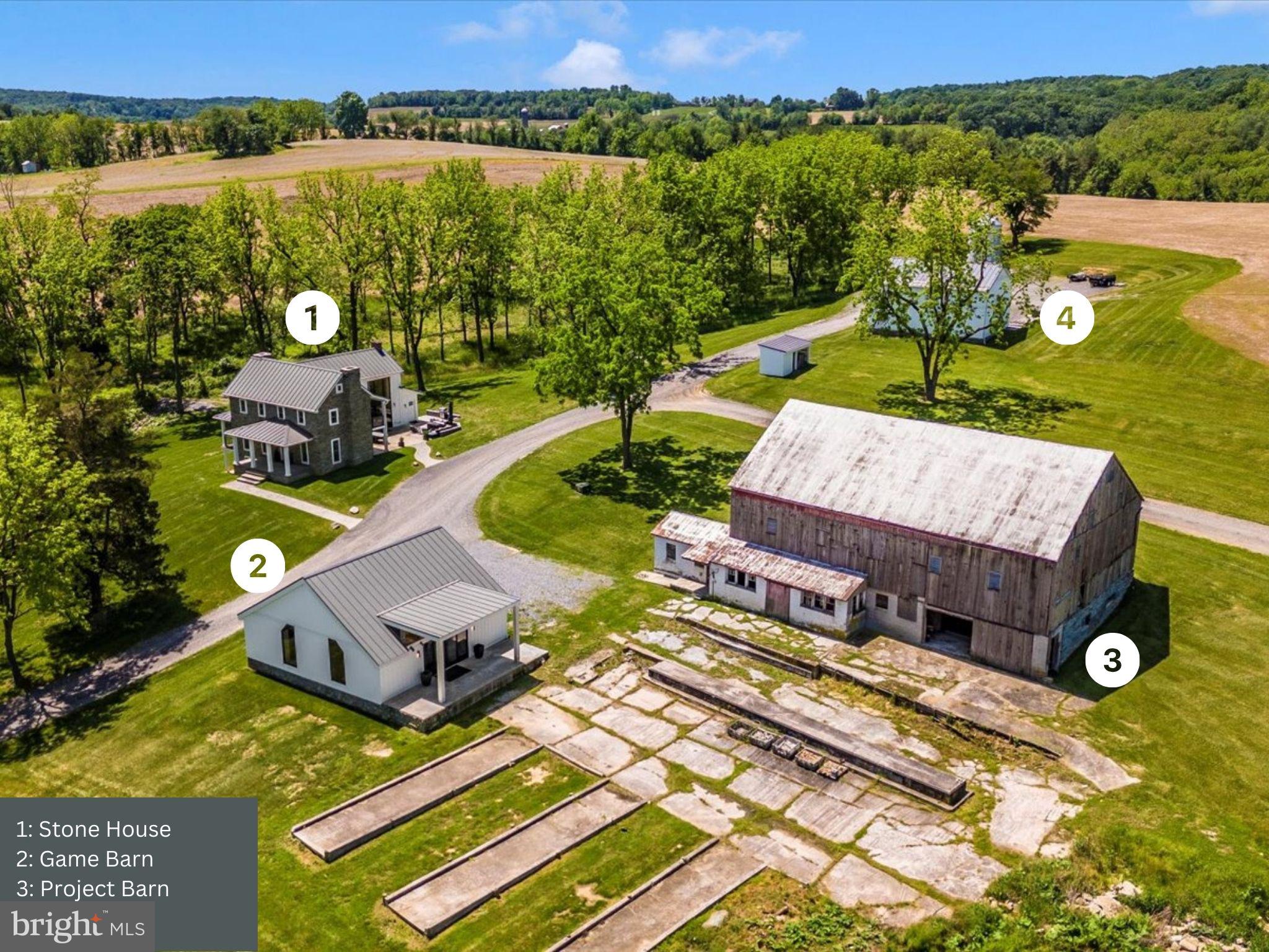 Experience serene living on this unique 88-acre estate, where vintage charm meets modern luxury. The main house showcases wide plank wood floors and original stonework throughout, blending historical elegance with contemporary design. The spacious living room features a brick fireplace, perfect for cozy evenings, while the dining room is ideal for gatherings. Enjoy stunning morning views from the breakfast room and cook in a kitchen with a fireplace, waterfall countertop, and patio access. The main level also includes a convenient half bath and a mudroom/laundry room.
Upstairs, the second floor offers a master bedroom with floor-to-ceiling windows and an en-suite bath, along with two additional spacious bedrooms and one full bath. The basement is an entertainer’s dream with a bar and fireplace, perfect for hosting friends and family. Relax on the porch and soak in the scenic views of this stunning property.
Outbuildings include a game barn with a modern exterior and original interior, a project barn ready for improvements, a spacious car and vehicle garage, and a tenant house featuring 2 bedrooms and 1.5 baths. Whether you're looking for a peaceful retreat, a working farm, or an entertaining haven, this property perfectly blends the old and the new. Plus, a newly paved driving path extends throughout the entire estate, adding convenience and charm.