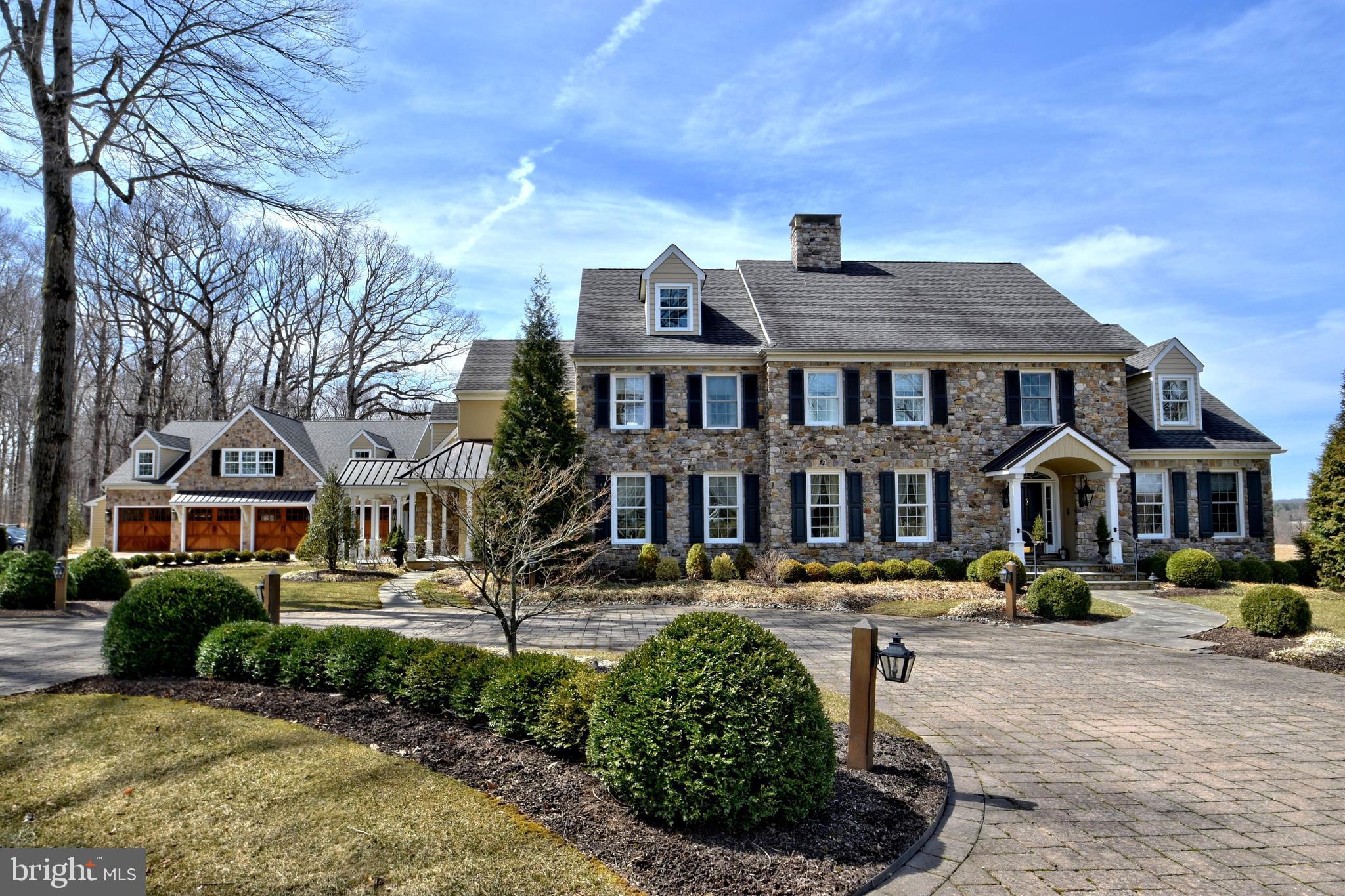 This Estate home was handcrafted by Richard Zaveta Custom Builder and sits majestically on a 7.34 acre parcel in the community of Buckingham Township. Exquisite attention to every detail and meticulously handcrafted, this home is full of custom amenities! Enter down a long drive with convenient circular driveway and detached heated 8 car garage with indoor basketball court! There is additional parking for guests and an outdoor basketball court as well. The grounds are professionally maintained and features custom paver walkways and patios. The rear yard features in ground pool, custom patios and built in gas grille, perfect for outdoor entertaining! Enter through a dramatic 2 story grand foyer with stunning chandelier and sweeping staircase! Formal living room with fireplace, French door entry to the formal dining room with access to the well equip Butlers Pantry. The kitchen is fit for a gourmet chef with tope of the line appliances, Wolf 6 burner stove, double wall oven, microwave, center island with vegetable sink, Sub Zero refrigerator and walk in pantry. Large breakfast bar with stools for additional seating divides the sun drenched breakfast room from the kitchen area. A stone fireplace adds warmth to the breakfast room as well. There is a full bath and 3 season room with access to rear grounds, pool and patio, Convenient 1st floor study with custom built-ins, an additional casual living room with walls of windows, fireplace and recessed lighting. Adjacent, a sunken family room for gatherings. Adjacent to the gourmet kitchen is an additional Trueblood inspired and built Great Room addition which is the ultimate entertainment center. Featuring custom box beamed ceilings, wet bar and a wall to wall stone fireplace just a perfect way to enjoy watching professional sporting events with friends. Above is an exquisite master suite with sitting room, 2 walk in closets and opulent bath with magnificent long distance views. The 3 additional bedrooms have the benefit of private baths and there are convenient laundry rooms on both the 1st and 2nd levels. The lower level is finished with 2 additional bedrooms and full bath, kitchenette / dining area, game room, media room with wall to wall built ins, exercise area, wet bar, wine cellar and additional unfinished areas perfect for storage.