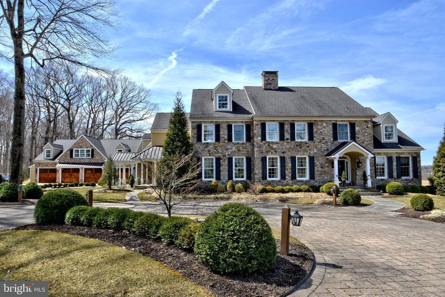 This Estate home was handcrafted by Richard Zaveta Custom Builder and sits majestically on a 7.34 acre parcel in the community of Buckingham Township. Exquisite attention to every detail and meticulously handcrafted, this home is full of custom amenities! Enter down a long drive with convenient circular driveway and detached heated 8 car garage with indoor basketball court! There is additional parking for guests and an outdoor basketball court as well. The grounds are professionally maintained and features custom paver walkways and patios. The rear yard features in ground pool, custom patios and built in gas grille, perfect for outdoor entertaining! Enter through a dramatic 2 story grand foyer with stunning chandelier and sweeping staircase! Formal living room with fireplace, French door entry to the formal dining room with access to the well equip Butlers Pantry. The kitchen is fit for a gourmet chef with tope of the line appliances, Wolf 6 burner stove, double wall oven, microwave, center island with vegetable sink, Sub Zero refrigerator and walk in pantry. Large breakfast bar with stools for additional seating divides the sun drenched breakfast room from the kitchen area. A stone fireplace adds warmth to the breakfast room as well.  There is a full bath and 3 season room with access to rear grounds, pool and patio, Convenient 1st floor study with custom built-ins, an additional casual living room with walls of windows, fireplace and recessed lighting. Adjacent, a sunken family room for gatherings. Adjacent to the gourmet kitchen is an additional Trueblood inspired and built Great Room addition which is the ultimate entertainment center. Featuring custom box beamed ceilings, wet bar and a wall to wall stone fireplace just a perfect way to enjoy watching professional sporting events with friends. Above is an exquisite master suite with sitting room, 2 walk in closets and opulent bath with magnificent long distance views. The 3 additional bedrooms have the benefit of private baths and there are convenient laundry rooms on both the 1st and 2nd levels. The lower level is finished with 2 additional bedrooms and full bath, kitchenette / dining area, game room, media room with wall to wall built ins, exercise area, wet bar, wine cellar and additional unfinished areas perfect for storage.