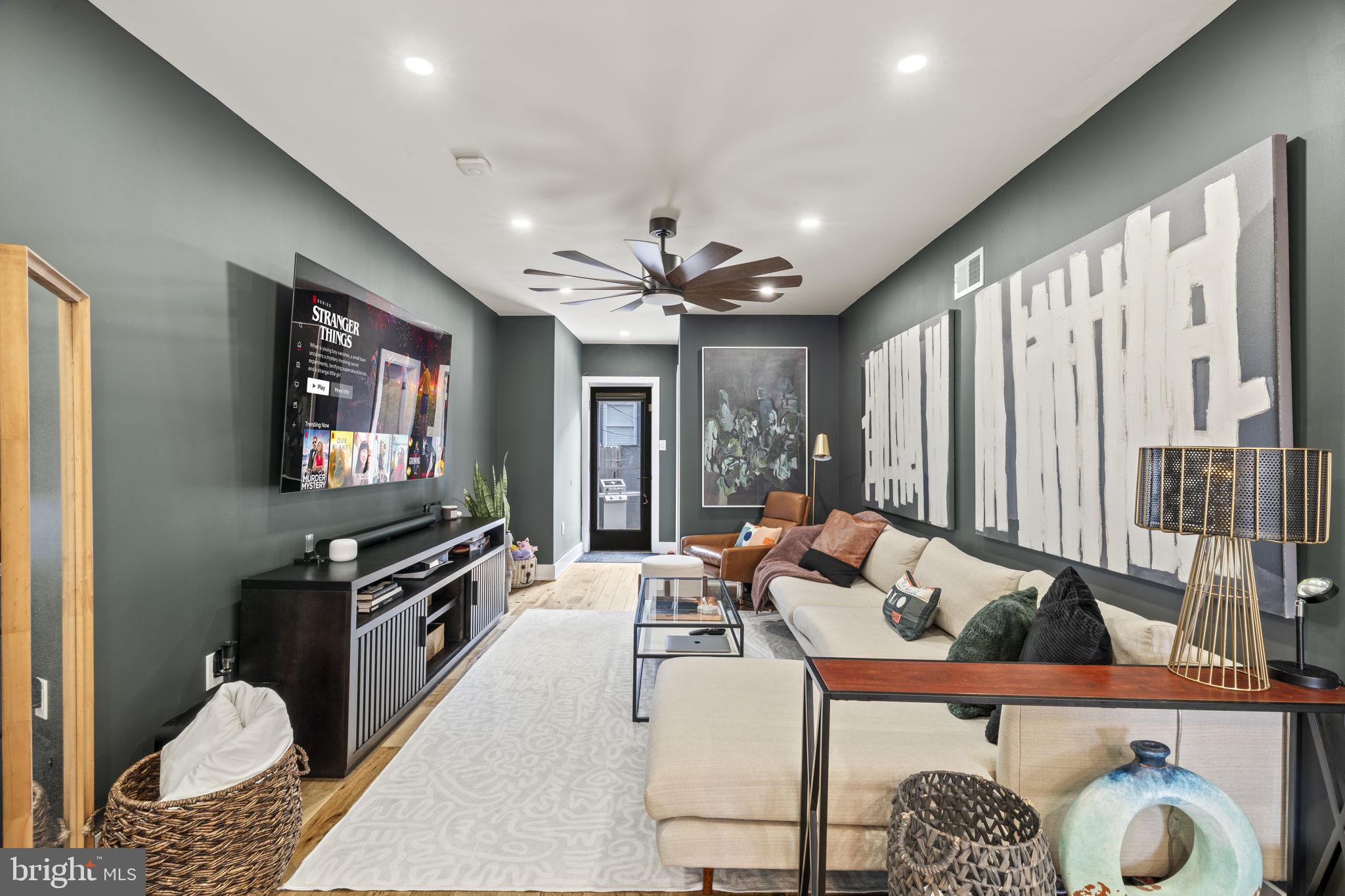 ***Up to $15k in Grants & Lender Credits Available for Downpayment*** This isn't your average South Philly rowhome! Step into a beautifully renovated home where charm meets elegant design and finishes on a peaceful, tree-lined street. This spacious 3-bed, 2.5-bath sanctuary, meticulously updated is ready for a new owner to move right in and unpack. The main level is a masterclass in flexible living. The curated front room, currently used as a dining area, complete with sleek, custom built-in storage, flows into a central, state-of-the-art kitchen. Here, you'll find elegant quartz countertops, high-end stainless steel appliances, and a stunning center island with a waterfall edge. A designer powder room adds a touch of sophistication behind the cozy living room area, while the large patio out back offers a seamless transition for indoor-outdoor living and entertaining. Upstairs, the primary suite is a true retreat. It features dual closets and an attached full bath with a glass enclosed shower, creating a spa-like feel. This floor also includes two additional bedrooms, with one being utilized as a cleverly designed office space. They both share a stylishly tiled hall bath. The finished basement is an entertainer's dream, featuring modern tile flooring and a dry bar with a wine fridge. A separate finished laundry area provides extra storage and convenience. Last but not least, that this home also comes equipped with solar panels for energy efficiency (currently leased). This home offers the best of both worlds- tree-lined living with quick access to the city's pulse as it is close to nearby I-76, making those Center City or Jersey commutes a breeze, minutes from the airport, and the vibrant restaurants and bars across various neighborhoods. Get ready to move in and immediately unpack! ***Up to $15k in Grants & Lender Credits Available for Downpayment***