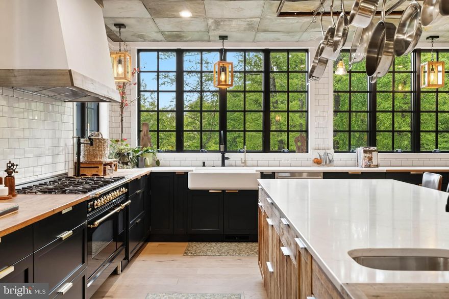 Laurelford. The house you’ve driven by and later dreamt about, never thinking it would be available...and here it is. Centrally nestled in the neighborhood, this masterpiece is just as gorgeous on the inside as it is from the street. A stately brick traditional anchored in symmetry, completely reimagined in 2020 adding a stunning three-story additional to the back. A beautiful blend of textures and materials, both old and new, balancing edge and soul and wrapping it into one. Timeless painted brick paired with contrasting hardiplank, reclaimed wood accents adjacent sleek black windows, the classic front porch and custom front door with operable side lights… Step inside and be inspired. Completely renovated from top to bottom, this home is meant to elevate your every day. A show-stopping kitchen designed to truly be the heart of the home. A chic yet comfortable space where you eat, live and play, complete with 6 burner Ilve range, built-in plumbed Miele coffee maker and wrapped in glass with a backdrop of greenery. Oversized French sliders offer the indoor/outdoor connection you are craving, beckoning you out to spacious covered loggia with built-in Napoleon Prestige grill. First floor offers a very flexible floor plan with versatile rooms meant to mold to your lifestyle. Upstairs offers plenty of space with three generously sized en-suite bedrooms and gorgeous second floor lounge which could easily serve as additional bedroom. The new luxe primary suite with covered balcony lives above kitchen and feels like you’re in a treehouse. Step up one more level to find two large bedrooms and spacious full bathroom. Downstairs, awaits your fully finished, walk-out lower level with full bath, rec spaces, a bar with the works, and glassy gym with doors leading to private lush backyard. An incredible home for both entertaining and everyday living, minutes from everywhere you want to be. The art of uniting human and home.