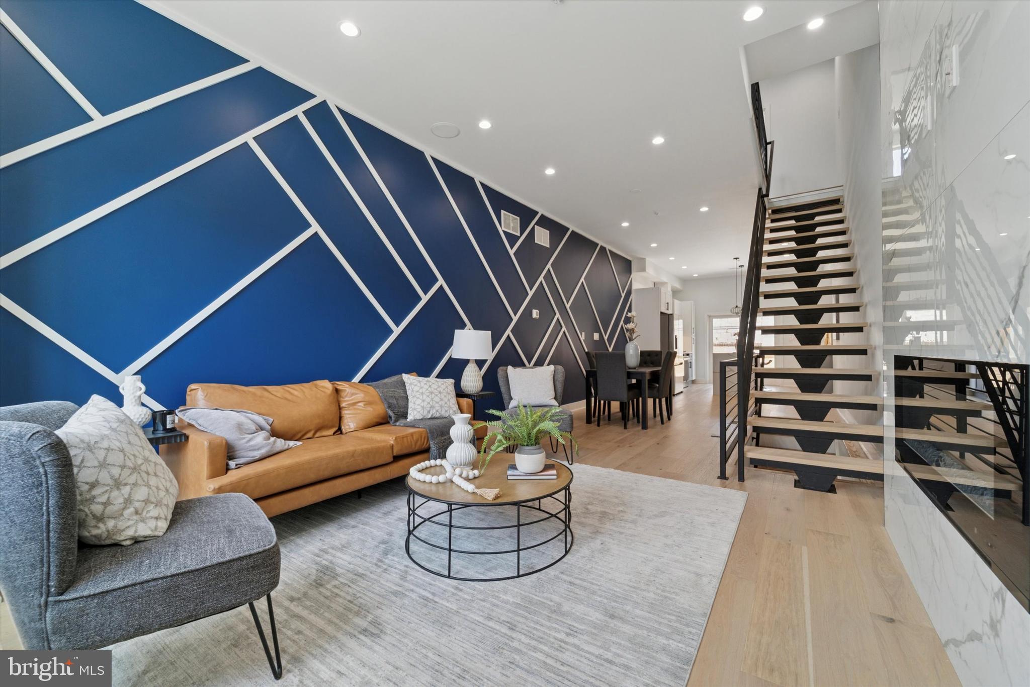 Don’t miss this stunning brand-new 3-bedroom, 3-bath townhome in the heart of Port Richmond. From its sleek moody gray façade to its thoughtfully designed interior, this home impresses at every turn.
The main level boasts a bright, straight-through layout with a spacious family room, dining area, and gourmet kitchen. Light white oak hardwood floors balance beautifully against a bold blue accent wall, creating an inviting, modern aesthetic. The kitchen is a true showstopper—featuring a marble waterfall island, crisp white cabinetry, and premium finishes. A sliding glass door opens to a private, fenced-in courtyard, perfect for morning coffee or dining al fresco.
Upstairs, you’ll find three bedrooms, including a dreamy primary suite with tray ceilings, recessed lighting, generous closet space, and a spa-like marble bathroom. Indulge in the luxurious soaking tub, enjoy the walk-in shower, and appreciate the sleek floating double vanity. Step outside to your private balcony for a quiet retreat. The second full bath offers a tub/shower combo with dramatic black marble tilework for a sophisticated touch.
The finished basement expands your living space with endless possibilities—a media room, home office, or extra family room—plus a third full bath with a large walk-in shower.
For even more outdoor living, head to the expansive roof deck where panoramic city views await.
Situated in sought-after Port Richmond, this home offers easy access to major shopping destinations like Target, Home Depot, ShopRite, and Petco, as well as convenient commuting via I-95. Tax abatement has been applied for.