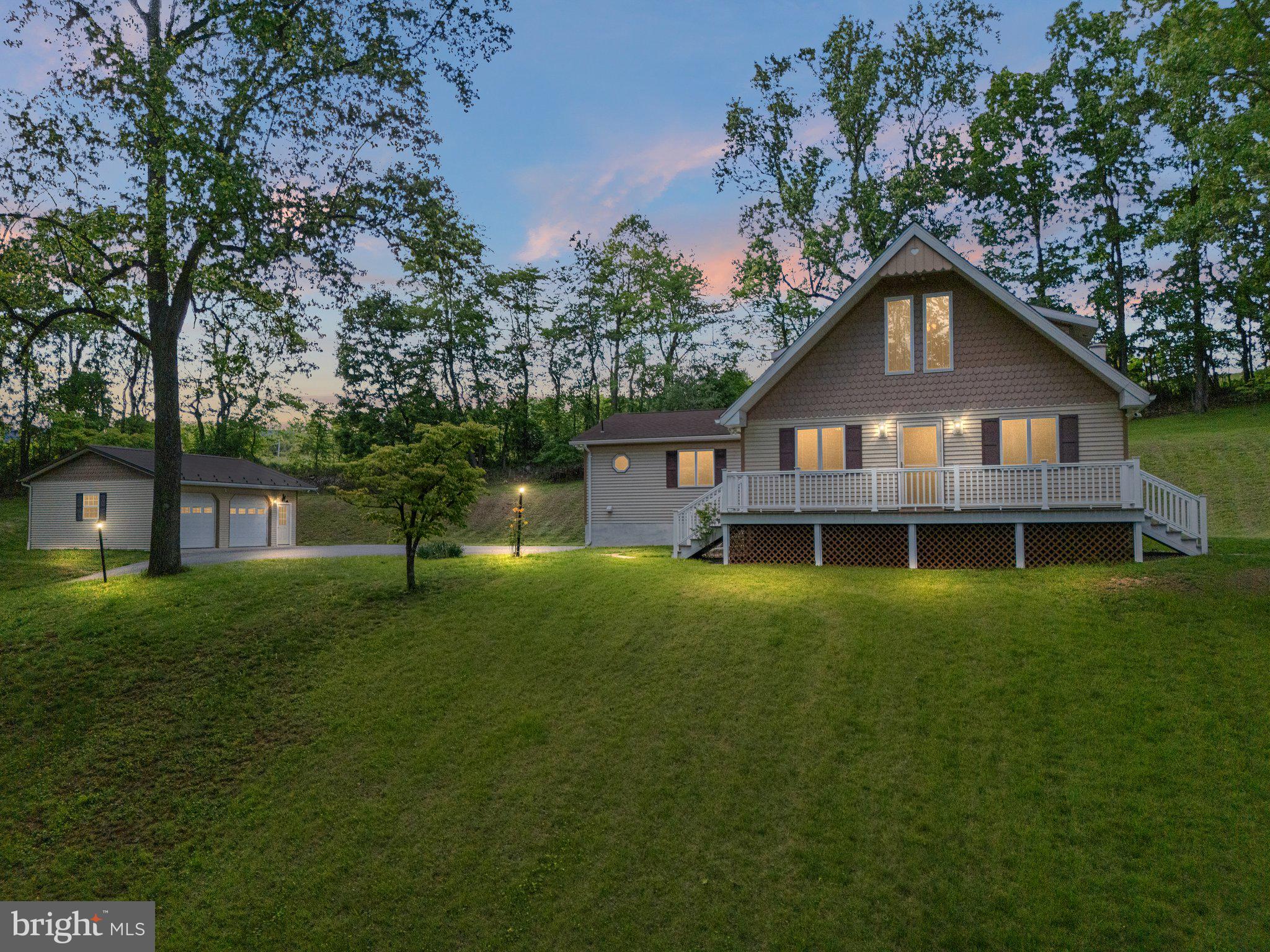 Set on 3.2 private acres in scenic Washington Township, Berks County, this unique 3-bedroom, 2.5-bath home offers a blend of rustic charm and open-concept living. Perched atop a gentle hill, the property provides elevated views and a peaceful, natural setting.
Step inside to a warm and inviting interior featuring wood ceilings, high vaulted spaces, and a spacious open floor plan. A custom-crafted wood railing with Mickey Mouse cut-outs adds a playful and personal touch to the main living area. Upstairs, a loft area overlooks the main living space, ideal for a home office, reading nook, or flexible use.
Outdoor living is just as impressive, with both a front and rear deck perfect for relaxing or entertaining. Car enthusiasts or hobbyists will appreciate the TWO detached 2-car garages, offering ample storage and workspace.
Geo thermal HVAC system with a propane back-up heating system.
A truly special property for those seeking space, character, and a touch of whimsy in a serene country setting.