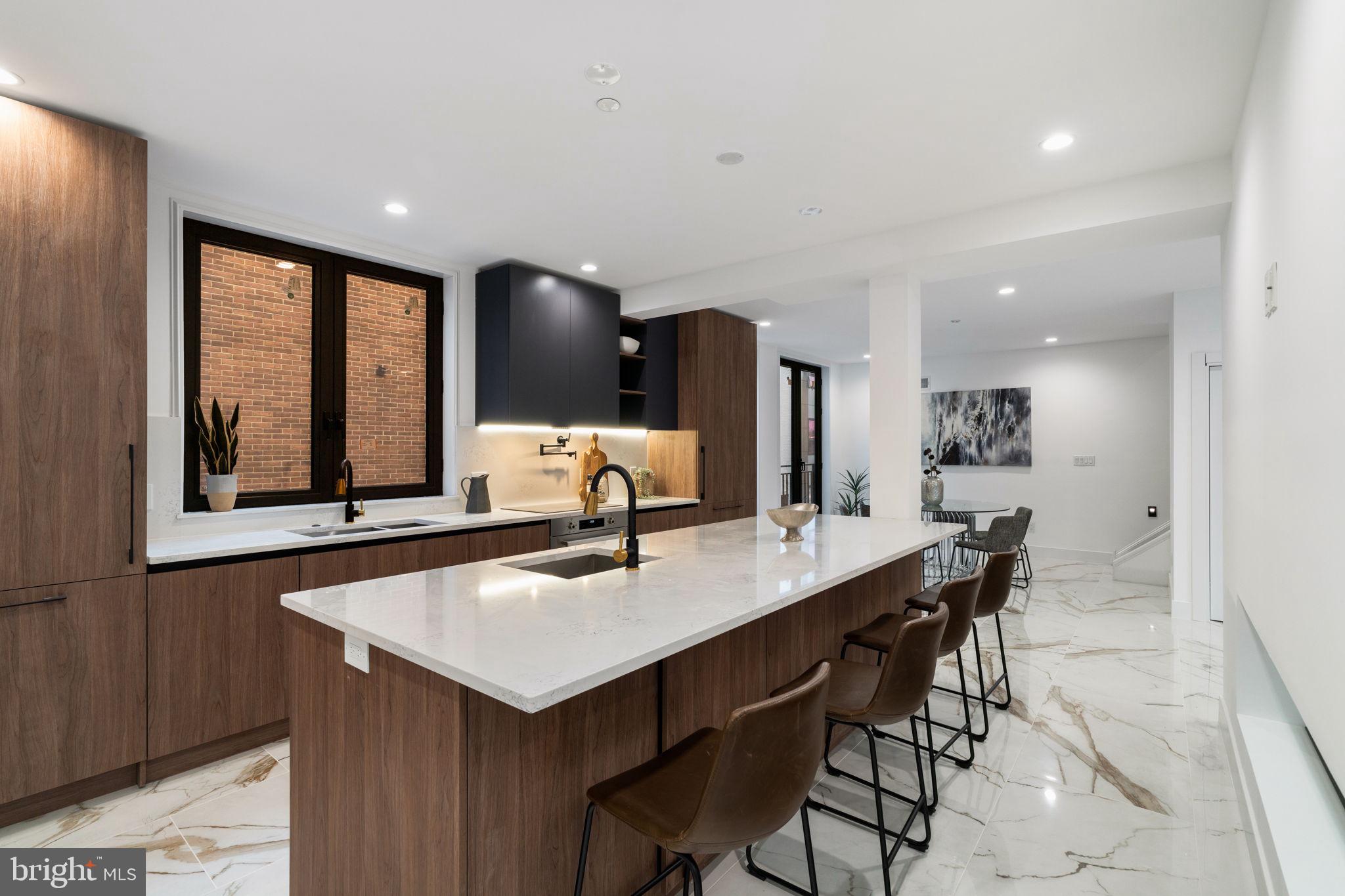 Introducing The Townhomes at Bella Vita—a gated community offering unparalleled privacy, elegance, and luxury. These stunning 4- and 5-bedroom homes are thoughtfully designed with high-end features, including elevators, expansive roof decks, 2-car garages, and tax abatements, creating an exceptional lifestyle experience. Nestled in the heart of Philadelphia, this exclusive community harmoniously blends style, technology, and comfort. Each meticulously designed residence features an open-concept layout, bathed in natural light from imported Italian floor-to-ceiling windows that frame captivating views of the vibrant cityscape. Italian tile flows seamlessly throughout, exuding understated opulence. Unit 10 offers 5 bedrooms and 3.5 bathrooms, with every detail crafted to perfection. The gourmet kitchen serves as a culinary masterpiece, complete with sleek, cabinet-integrated appliances, a built-in wine refrigerator, and an oversized central island perfect for entertaining. A spacious walk-in pantry ensures all your cooking essentials are conveniently at hand. The primary suite is a private retreat, featuring a spa-inspired bathroom with a luxurious soaking tub, a walk-in rain shower, and exquisite finishes that evoke serenity and indulgence. Each en-suite bedroom combines elegance with functionality, providing a private haven for every member of the household. Upper-level bathrooms feature radiant heated floors, delivering unmatched comfort. Adding to the allure is a private 5-stop elevator that effortlessly connects all levels, including an expansive rooftop deck. From this panoramic perch, enjoy breathtaking views of Philadelphia’s skyline, iconic bridges, and sports arenas. Whether hosting a rooftop gathering or savoring a quiet evening under the stars, this space is a true highlight of the home. Bella Vita homes are equipped with cutting-edge smart home technology, allowing you to control dual-zone HVAC, lighting, full-house surround sound, and even the garage door via tablet or smartphone. Every detail has been carefully considered to enhance your lifestyle. Situated in a secure, gated community, Bella Vita offers both convenience and peace of mind. Features include a two-car garage, additional off-street parking, and easy access to public transportation, major highways, and Philadelphia’s premier cultural and entertainment destinations. This is more than a residence—it’s a statement of elegance, craftsmanship, and modern luxury. Corner homes are available. Taxes and square footage are the responsibility of the buyer to verify independently. The PAR Standard Agreement of Sale for New Construction of sale must be used for new construction properties whether completed or not.