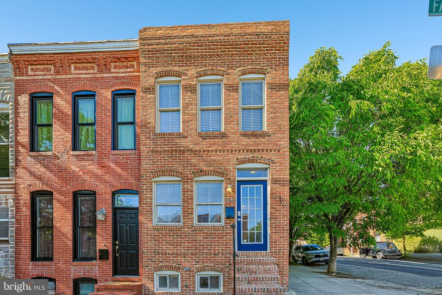Experience elevated city living in this beautifully upgraded end-of-group Canton home, featuring a rear garage, panoramic rooftop views, and premium finishes throughout. Flooded with natural light from multiple exposures, this exceptional residence offers an open-concept layout with high ceilings, elegant crown molding throughout, recessed lighting in every room, and Brazilian cherry hardwood floors, adding rich warmth, depth, and a timeless elegance that elevates the entire home.

The main living space is thoughtfully designed for both comfort and entertaining, featuring expansive living and dining areas with a seamless flow into a beautifully appointed kitchen showcasing timeless black granite countertops, stainless steel appliances, a double oven gas range, a bottom-freezer drawer refrigerator, and under-cabinet lighting that enhances both function and style. A striking focal point is the custom wrought iron floating staircase, adding architectural character and a modern edge. The living room is further elevated by an elegant tray ceiling that adds depth and visual interest, and is pre-wired for surround sound, offering an enhanced entertainment experience.

The primary suite provides a relaxing retreat, complete with vaulted ceilings, a spacious walk-in closet, and a beautifully designed en-suite bath featuring dual vanities, a soaking tub, and a separate shower. Full-size washer and dryer are conveniently located on the upstairs bedroom level. 
Enjoy outdoor living at its finest on the private rooftop deck with incredible panoramic views of downtown Baltimore, Fort McHenry, and seasonal fireworks displays.

The lower level has been thoughtfully updated to include a private, fully enclosed bedroom with two front-facing windows that bring in abundant natural light. Fully carpeted throughout, the level also features a centrally located flex space—ideal for a home office, workout area, or additional living space.
Additional highlights include a full-size rear-entry garage with an extra-wide door, keyless Wi-Fi–enabled locks on exterior doors, and a pre-wired security system with existing window and door sensors and a motion detector, with system components in place and ready for activation.
Ideally located just blocks from Canton Square, Merritt Athletic Club, Harris Teeter, and Sprouts, this home offers the perfect blend of luxury, convenience, and vibrant city living.