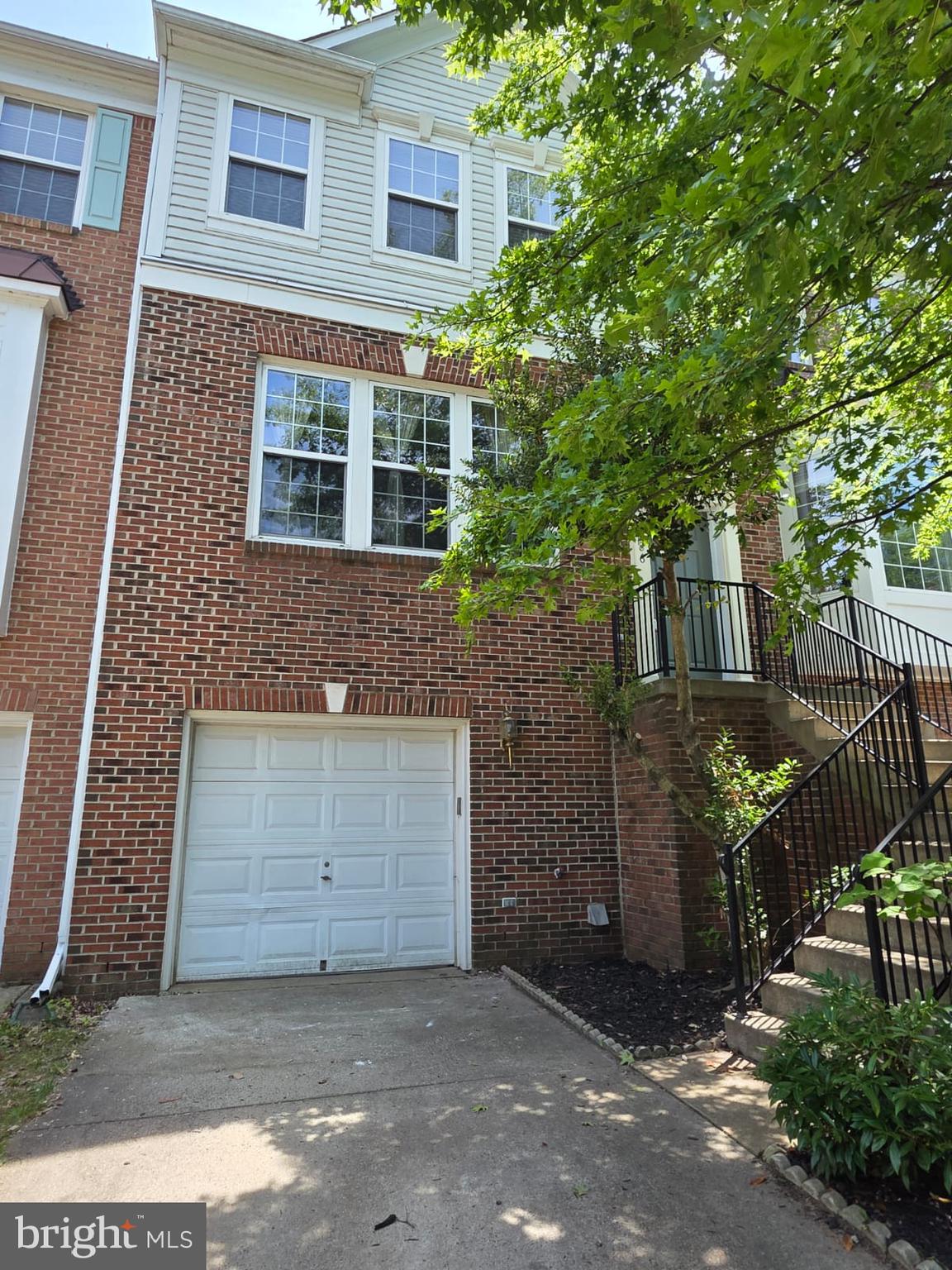 Beautiful brick-front townhome with a 1-car garage and three fully finished levels. The main level features a spacious, open-concept living room and a step-up formal dining room with soaring 9-foot ceilings. Enjoy a cozy family room and an open country-style kitchen complete with hardwood floors, 42-inch cabinetry, upgraded GE appliances, and a sunny breakfast area. Step out onto the rear deck with stylish under-rail lighting—perfect for relaxing or entertaining. The lower level offers a versatile rec room with a fireplace and a convenient half bath. Upstairs, the primary bedroom includes a walk-in closet. Located less than half a mile from the Greenway, this home offers comfort, space, and convenience in one great package!