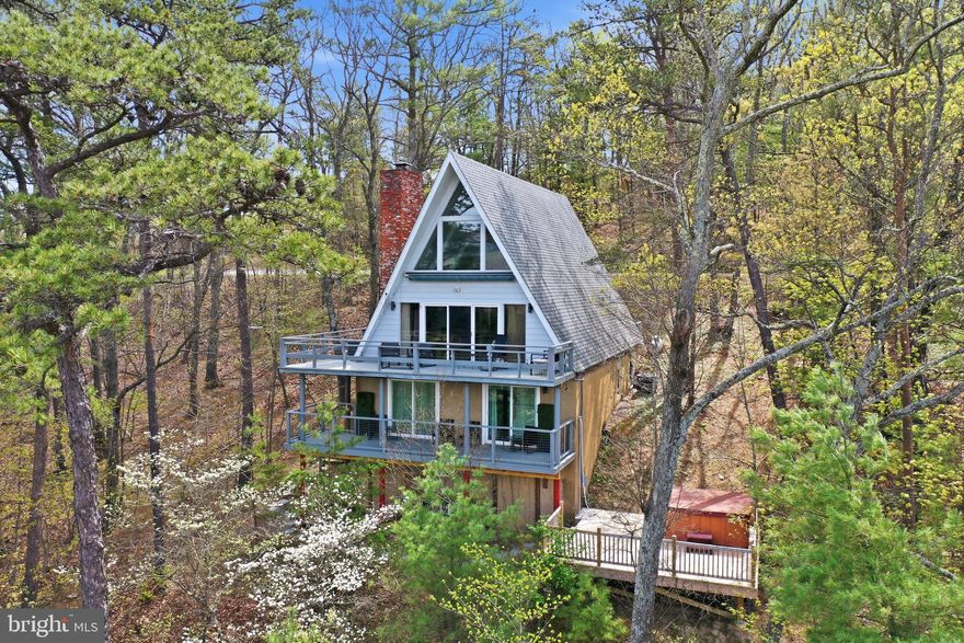 The ultimate Bryce Resort Property! – Proven Short-Term Rental! Welcome to 197 Aspen Way S., a beautifully maintained and thoughtfully updated chalet nestled in the heart of Bryce Resort. This exceptional property offers  a stunning view of the valley.   The perfect blend of mountain charm, modern upgrades, and is directly on the skiing/mountain bike trails —making it an ideal full-time home, weekend retreat, or investment opportunity with a strong short-term rental history. Step outside and you’ll immediately appreciate the panoramic views from the  wraparound deck, ideal for entertaining or relaxing in the fresh mountain air. The private hot tub deck offers  seclusion—your own personal oasis in the Shenandoah Valley. Inside, the home showcases a warm, inviting professionally designed interior with meticulous attention to detail. Enjoy newly remodeled bathrooms featuring luxurious heated floors, mirrors and towel racks.  Create meals in the updated kitchen complete with granite countertops and modern appliances—perfect for preparing meals after a day on the slopes or the golf course.  Sleep peacefully as you enjoy the sound proof insulation that was added to all bedroom walls. The location,  on a cul-de-sac,  couldn’t be more convenient—just minutes from all the resort amenities. Whether you're into skiing, mountain biking, 18-hole championship golf, swimming, fishing, pickleball, or simply enjoying the natural beauty of the mountains, Bryce Resort has something for everyone, year-round. This chalet is not just a home—it’s a turnkey investment with a proven track record as a short-term rental. Rental history and financials are available upon request—just ask your agent. Don’t miss your opportunity to own this exceptional property in one of Virginia’s most desirable resort communities. Schedule your showing today and experience all that this unique home has to offer!