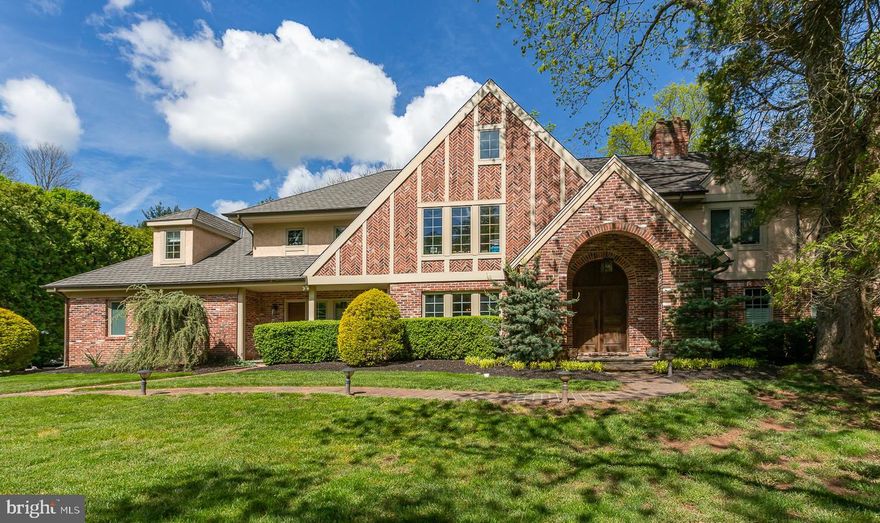 Exceptional Tudor-style home completely reimagined/rebuilt over time by its current owners. Sited on a flat lot, and set back from the cul de sac, 1238 Page Terrace boasts extraordinary features and finishes throughout. Open concept floorpan allows for both large scale entertaining, and comfortable, everyday family living. Two-story entry with graceful, turned staircase.  The heart of the house is the custom Kountry Kraft kitchen with oversized island, inset cabinetry, natural stone counters, slab backsplash, pro-style appliance suite, and casual dining space/morning room. Kitchen opens to the family room with 18’ ceilings, custom built-ins, wet bar, fireplace, and two-story wall of windows/doors overlooking the bluestone patio. Sliding barn doors from family room to separate living room featuring a bay window-seat and wood burning fireplace with marble surround.  Formal dining room with corner china cabinets. Wood paneled library/office with fireplace and built-ins adjoins the main floor primary suite, a retreat with luxe, spa-inspired bath and it’s own doors to the patio and rear yard. There is a separate family entrance just off the kitchen to the mudroom that accesses the attached 3-car garage, laundry room, back stairs, and one of two main level half baths. Rear yard with extensive hardscaping and mature perimeter landscape affords maximum privacy.  Second floor: 5 well-proportioned bedrooms, 4 recently renovated baths (3 en-suite), and a ‘bonus room/den. Third floor houses gym, media room and additional storage. Flexible floor plan affords the possibility of either a first floor primary suite (as current owners use the space), or a second floor suite. Low taxes! Don’t miss the opportunity to make this magnificent Villanova home your own. Close proximity to everything that makes the Main Line an incredible place to live, and award winning Lower Merion schools.