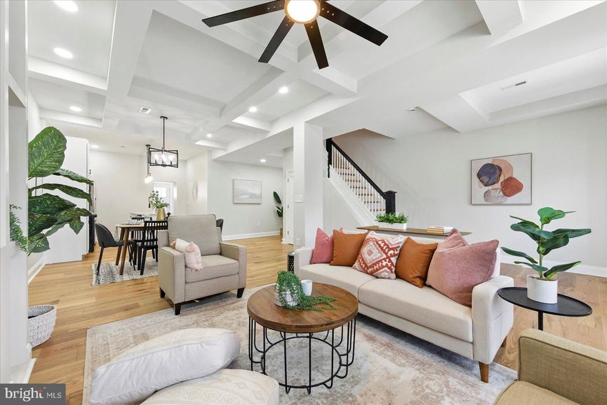 A beautiful transformation has taken place behind the doors of this 5BR/4BA double wide Townhome located in the quiet neighborhood of Evergreen Lawn.  Beginning at the stunning entrance featuring stately stone columns, a covered porch, and a glamorous entry door.  Open the door into your new home and take in all the glamour and attention to detail that has created this stunning main floor featuring tons of natural light, an open concept floor plan, custom coffered ceiling, engineered hardwood floors, and a soft color palette. The main floor boasts a grand sized living room with bowed windows and a gas fireplace feature surrounded by custom shelving, a large dining room, a stunning kitchen, and a main floor bedroom and full bath with a walk-in shower.  The kitchen features plenty of cabinets including a pantry cabinet, stainless steel appliances including a slide-in gas range, sleek quartz countertops with a complementing tiled backsplash, and an island with a double stainless sink and pendant lighting.  The stairs to the second floor features an original ballister post and leads you to the newly carpeted second floor offering two sizable secondary bedrooms, a full bath, and a grand primary suite.  The oversized primary features tons of natural light, a gas fireplace feature, a large walk-in closet, and a private bath boasting a beautifully tiled walk-in shower.  The lower level is finished offering additional living space featuring the fifth bedroom, a full bath with walk-in shower, a large family room, laundry and storage.  From the main floor step outside to a newly fenced yard with a newly constructed wood deck that overlooks a yard with tons of possibilities.  This home is move-in ready and is located in close proximity to shopping, restaurants, and commuter routes.