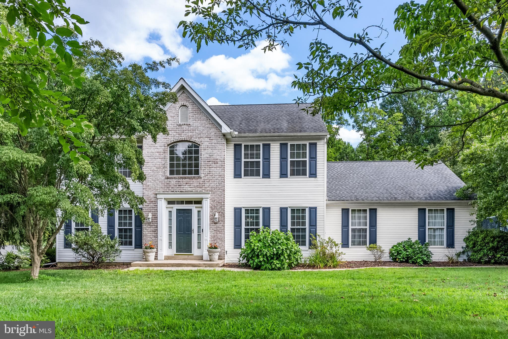 Discover this exceptional and seldom available home, showcasing one of the largest models in the highly desirable Bancroft Woods community. The updated kitchen features timeless white cabinetry, complemented by newer appliances and granite countertops. The family room offers sliding doors that open to a stunning sunroom and Trex deck,. The spacious family room is enhanced by a charming brick fireplace. On the first floor, you'll find a living room, dining room, a convenient laundry room, and a powder room, all connected by a welcoming foyer. Upstairs, the master suite is generously sized, offering a walk-in closet and a master bath equipped with a garden tub, stall shower, double sink, and linen closet. The second floor accommodates three additional spacious bedrooms and a hall bath. The finished walk-out basement provides additional living space with brand new neutral carpeting, recessed lighting, and versatile options for use as a game room, playroom, exercise room or hobby room. Newer Roof, Furnace and Main Floor Windows. Make this remarkable property your new home!