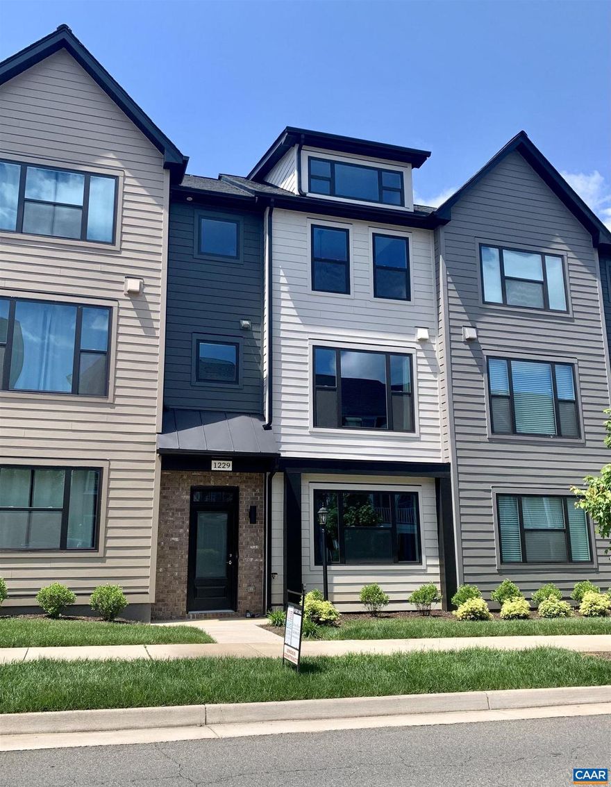Available Now! - This modern townhome in the heart of Old Trail boasts a plethora of upgrades.  The gourmet kitchen is a chefs dream, with stained maple cabinets, quartz counters, and a generously sized island with seating. High-end stainless appliances elevate the cooking experience.  Adjacent to the kitchen is a light-filled dining room area, spacious enough to host holiday gatherings and perfect for everyday dining. Upstairs, the owner's suite with vaulted ceiling and windows offers a haven of comfort. A large walk-in closet provides ample storage, while the private bathroom exudes luxury with dual vanities and a frameless glass walk-in shower. Two additional bedrooms, a full bath, and a conveniently located laundry room complete the upper level. The ground floor of this townhome boasts a fourth bedroom, which could serve as a guest room or a home office and features a full bath. Dine outdoors on the composite deck with mountain views and sunshade.   HERS Score 65 at purchase, Pearl Certified Gold.