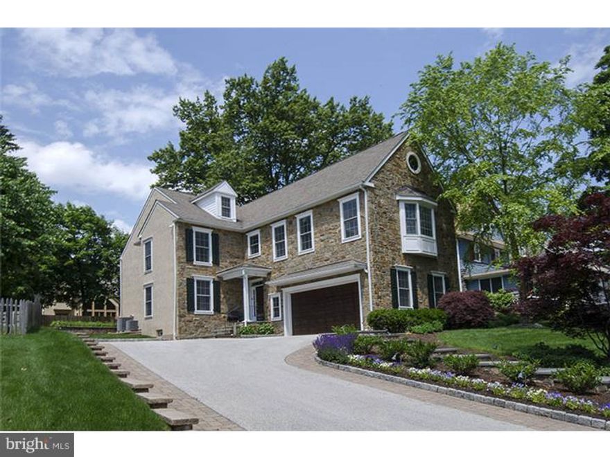 Classically styled five-six Bedroom, five and one half bath Stone Colonial home in pristine, neutrally appointed, move-in condition in the desirable walk-to neighborhood of Suburban Square.  Handsome, gleaming hardwood -floored Foyer opens to the left to the formal Living Room and Formal Dining Room with crown molding, hardwood floors and deep baseboard molding to the right. Beyond the flared stair, find a dramatic, two story Family Room enhanced with gas fireplace and full wall of windows offering views of the properties' manicured gardens and walled flagstone terrace.  The Family Room adjoins the Breakfast area and opens to a deluxe chef's Kitchen, highlighted with tiered granite seated and prep island, rich natural wood cabinetry, double ovens, inset gas cooktop, and tumbled marble backsplash. An open arched doorway leads back to the formal Dining Room, creating an open floor plan in the informal area of the home and separate, formal space as well.  Ascend the stair to a Master retreat.  The bedroom enjoys a volume ceiling, ceiling fan, and bay window overlooking the front grounds. The Master joins a walk-in closet and large neutrally tiled bath with an under-window jetted tub, standing shower, and double vanity sink with marble top. Three other family Bedrooms are on this level, one with an en-suite bath, and the other two with a generously sized Jack and Jill bath.  The third floor offers a Sitting room/Office, fifth Bedroom and full Bath.  Fully finished Lower Level with day light windows provides expanded entertaining and recreation space with Craft room/Office, wet bar, and custom cherry wood floor to ceiling cabinet/bookcase unit equipped with TV and surround system. Additional storage and full Bath complete the Lower Level. A turnkey residence a block from Suburban Square.