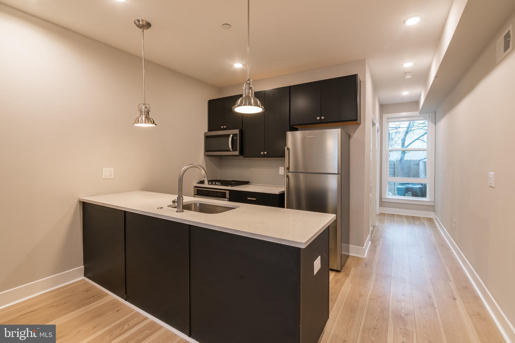 *Available 11/1!*
A fantastic 2 bedroom, 2 full bathroom apartment in a new construction building with quick access via trolley or bus routes to University City! The first floor includes a spacious open floor plan living room and kitchen with quartz counter tops and breakfast bar, black cabinets and stainless steel appliances. Towards the rear of the apartment is the hall bathroom with a shower/tub and vanity that matches the kitchen. The bedroom includes a large closet and access to the back patio. Downstairs in the finished basement is the washer/dryer, additional communal space for a TV room or home gym, and the second bedroom with an en-suite bathroom and additional access to the back patio. You will also enjoy hardwood floors, central air and recessed lighting!
Lease Terms: Generally, 1st month, and 1 month security deposit due at, or prior to, lease signing. Other terms may be required by Landlord such as last month’s rent upfront. $65 application fee per applicant. electricity, gas (if applicable), cable/internet and $10/mo technology fee. Water is a flat monthly fee of $75. $25 service fee plus cost of the air filter will be charged quarterly for routine air filter replacement. Landlord Requirements: Applicants to make 3x the monthly rent in verifiable gross income, credit history to be considered, no evictions within the past 5 years, and must have a verifiable rental history with on-time rental payments. Exceptions to this criteria may exist under the law and will be considered. Cosigners will be considered.
*Pets permitted – Cat or Dog, subject to owner approval. $500 nonrefundable deposit required.