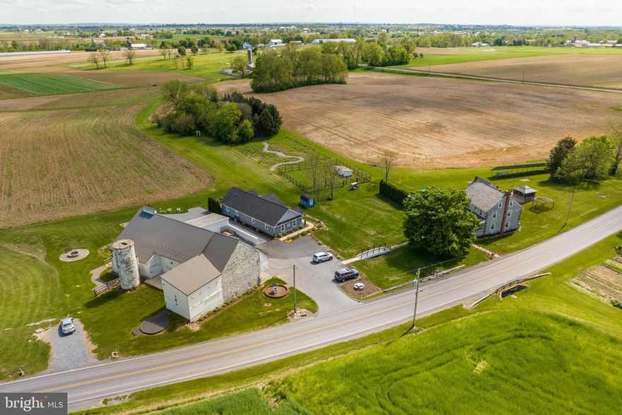 THIS IS A PRIVATE AUCTION. THE LISTED PRICE IS AN OPENING BID ONLY AND IS NOT INDICATIVE OF THE FINAL SALE PRICE. Offers are to be submitted by July 10th at 10 am. After bids have been reviewed, the top 3 bidders will have the opportunity to bid confidentially against each other at an appointed time. Terms 10% down, balance 60 days or before. Settlement on or before November 15, 2023. * Welcome to this exclusive private auction opportunity! Take a moment to envision your future in this remarkable 22.86 acre farm, boasting a 1820's stone farmhouse with a touch of historical elegance. This 3 bedroom bed & breakfast and event venue offers many possibilities and opportunities. * The main farmhouse spans 2.5 stories and offers a generous 2,583 square feet of finished living space. The heart of the home revolves around the inviting eat in kitchen, featuring FoxCraft custom oak cabinets, a spacious island with a stove, refrigerator and dishwasher. Skylights grace the living/dining room, illuminating the space with natural light. The laundry/mudroom boasts custom built in cabinetry, while the office provides wall-to-wall bookshelves, ideal for displaying your treasured literary collection. With a total of 5 bedrooms (including a primary bedroom with a fireplace and electric insert) and 2.5 baths, this residence ensures ample space for comfortable living. Discover additional delights, such as the reading room, alcove and the two basements, two attics and abundant storage throughout. Modern comforts are seamlessly integrated into this historical house with features such as oil forced air heat, central A/C and insulated windows. Special attention has been given to preserving the character of this historic home with deep window sills, restored woodwork and stunning, redone, PA pine hardwood floors. * Adding to the appeal is a second house. A delightful one-story stone/vinyl rancher, a perfect expansion for a bed and breakfast or in-laws quarters. Built in 2015 by Creekview Builders, this thoughtfully designed dwelling encompasses 1,588 square feet of finished space, complete with a kitchen, living room, laundry area, two bedrooms with Murphy beds, and three full baths. Enjoy the comfort of forced air heat and central A/C in this charming retreat. * The outbuildings on this property are a testament to its versatility and potential. A beautifully restored 1 story stone and frame Sweitzer bank barn, measuring 84x40, with additions of 10x34 and 20x66, includes four horse stalls and a new roof installed in 2022. The upper level has most recently entertained guests for weddings and other events. Adjacent to the barn is a convenient machine shed measuring 64x18, accompanied by a spacious barnyard of 42x40. Additional structures include a utility shed measuring 13x8, a chicken house measuring 10x20 and a detached bonus office building measuring 26x15, equipped with electric heating and window AC for maximum comfort. Delight in the outdoors within the 3-season gazebo measuring 14x14, resting upon a raised stone foundation. * The extensive grounds encompass 22.86 acres, offering a harmonious blend of fenced pastures, large grassy areas perfect for hosting events, a wildflower patch and 20 tillable acres. Immerse yourself in the stunning professional landscaping adorned with a fishpond, patios and a fire pit, creating a serene atmosphere for relaxation and entertainment. A remarkable 21 KW solar system and an above ground pool contribute to the environmentally conscious features of this property. Explore the picturesque bridge and walkway, adding a touch of whimsy to the landscape. The estate is serviced by four on-site wells and two septic systems. * Zoned Ag and benefiting from Clean & Green status, this property presents a tremendous opportunity to acquire a ninth-generation, meticulously maintained family farm. * Submit your bids by July 10th at 10 am to secure your chance to be part of the top 3+ bidders.