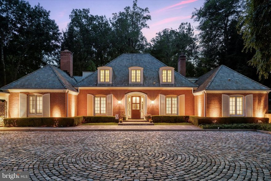 Discover unparalleled luxury in this French Provincial Manor Style property, situated on a rare double lot in the prestigious community of The Woods in Wayne. Located within the highly acclaimed Radnor School District, this custom-built home offers an exceptional level of refined living and a rare opportunity to reside in one of the area's most prestigious neighborhoods. It features a beautifully appointed main house with a tranquil pool and an elegantly finished basement, complemented by private guest quarters above an exquisitely crafted 2-car carriage house. Please note that the primary suite is on the second level and the additional bedrooms are on the main level. Also, the guest quarters and its private bathroom are considered a bonus and not included in the listed square footage, room count or the floor plans. Meticulously renovated, this property seamlessly blends timeless elegance with modern sophistication, showcasing exceptional design and state-of-the-art amenities. Experience expansive living spaces enhanced by cutting-edge smart home technology, all integrated into the classic aesthetic. The beautifully landscaped, private grounds feature a professionally designed garden, hidden reading nook, and an awning-covered veranda, enclosed by brick and wrought iron fencing.  This property boasts an array of upgrades and amenities so extensive that they couldn’t all be listed here. For a detailed overview, please refer to the comprehensive list of upgrades/amenities available in the documents section. This extraordinary property is the ultimate in refined living, offering a unique opportunity to call one of the region’s most sought-after neighborhoods home.