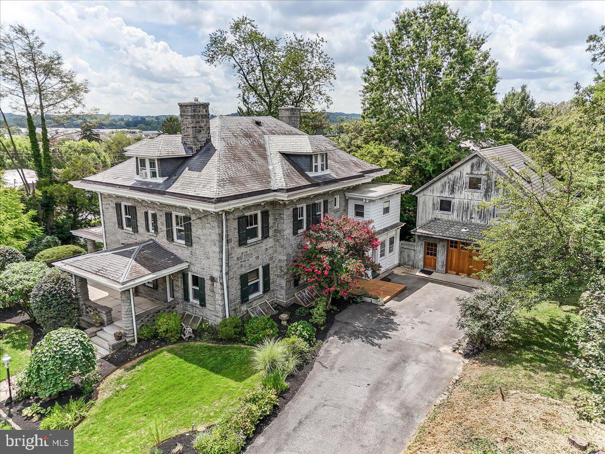 Welcome to 503 W State Street, a rare gem in the Heart of Historic Kennett Square. The Robert Scarlett House is a spacious and character-filled 7-bedroom, 5.5-bath home in the heart of historic Kennett Square. Offering over 4,100 square feet of living space across four levels, including a large unfinished basement, this beautifully preserved property blends historical charm with modern flexibility—perfect for those seeking a private residence, a multi-generational estate, or a one-of-a-kind investment property as. a Bed and Breakfast.
Built in 1910 by William Scarlett for his son Robert, this home is one of only three granite residences the Scarlett family constructed on West State Street—crafted from locally quarried granite, a rare and highly durable material that gives the home its signature strength and permanence. The Robert Scarlett House is a proud contributing property in the Kennett Square Historic District, which was added to the National Register of Historic Places in 1989. It also sits atop Hessian Hill, believed to be the site of a Revolutionary War encampment during the 1777 Battle of Brandywine.
Inside, the home is a stunning example of Arts & Crafts-era architecture, filled with original details that have been lovingly maintained. Chestnut millwork, red pine wood floors, and high ceilings bring warmth and authenticity to each room. The American Four Square layout emphasizes symmetry and function, with spacious formal parlors, a large dining room, and multiple three-over-one sash windows filling the home with natural light. Architectural highlights include a patterned slate hipped roof, partial jerkinhead gables, and a gracious full-width veranda—a classic signature of early 20th-century design. Whether you're restoring its former glory or enhancing it with modern comforts, this home is a true canvas for old-home enthusiasts.
From 1992 onward, the home operated as the Kennett House Bed & Breakfast, welcoming guests visiting Longwood Gardens, wineries, and the surrounding Brandywine Valley. Its flexible layout includes several en-suite bedrooms, making it an ideal candidate for a boutique inn or extended guest accommodations.
An added bonus is the detached garage with an upstairs studio, expertly constructed by local Amish carpenters and filled with natural light from multiple skylights—perfect for use as a home office, creative space, in-law suite, or guest retreat.
Located just blocks from downtown Kennett Square’s vibrant shops, restaurants, and events—and minutes from Longwood Gardens—this home is also situated in Chester County, which has been consistently named one of the Best Places to Live in America for its natural beauty, strong school systems, and rich quality of life. For those who appreciate historic architecture, rare building materials, and a true sense of place, 503 W State Street is more than a home—it’s a legacy waiting to be lived. SHOWINGS START FRIDAY 8/14. Join us 5-7pm for an Ice Cream Social and Open house for a first look at the property!
This property qualifies for a seller credit up to $12,500 (Sales Price 1,250,000) towards buyer’s closing costs or interest rate buy downs. Buyer is not obligated to use Bill Rookstool of CrossCountry Mortgage to have offer accepted however must use Bill Rookstool to qualify for the credit. - Restrictions apply. NMLS 137765, NMLS