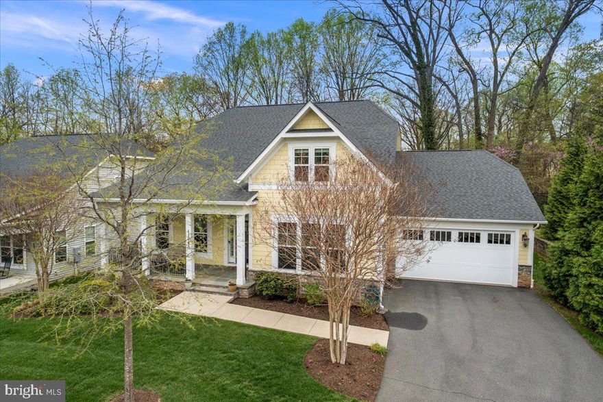 A rare opportunity to own this like-new Craftsman style home, built by Evergreene Homes in 2017, in a private community backing to trees and across the street from a park.  Lightly lived in by its original owners, and featuring a sought-after main level primary suite and open floorplan, this is the one!  As you enter, clear sight lines lead straight to the outdoor living space highlighting the home’s light and spacious design.  The gracious dining room is ready for entertaining, with new custom window treatments.  Across the entry hall, the dedicated office with glass French door is the perfect work from home space, overlooking the covered front porch.  Moving into the heart of the home, the designer kitchen is a chef’s dream with gas stovetop, stainless steel appliances, a butler’s pantry and a huge island for family and guests to gather.   All finishes are of the highest quality and include maple cabinets in ivory, quartz countertops in Alpine Spring, and ceramic backsplashes.  The primary suite boasts amenities you’d expect in a home of this caliber, with two roomy walk-in closets, a double sink silestone vanity, separate shower and soaking tub.  Also on the main level are a large family room featuring a coffered ceiling and spectacular stacked stone gas fireplace, a laundry room/mudroom leading to the oversized two car garage, and a powder room.  Other high end features include variable-width handscraped espresso hardwoods throughout and French doors leading to the lighted travertine patio with curved seating wall and firepit, seamlessly blending indoor and outdoor living.  The backyard is fully fenced, and all lawn maintenance is provided by the HOA!  Upstairs features 2 large bedrooms each with a dedicated full bathroom.  There is an additional bedroom and full bathroom in the lower level.  This level is also finished with a bright recreation room accessible to the backyard.  Storage is abundant with several bonus spaces just awaiting your customized gym, music room, or home theater (pre-wired).  Close to the center of Herndon with its charming and historic downtown and the popular W&OD bike path, and easily accessible to Reston Town Center, the Dulles tech corridor, and all commuter routes, the location can’t be beat!