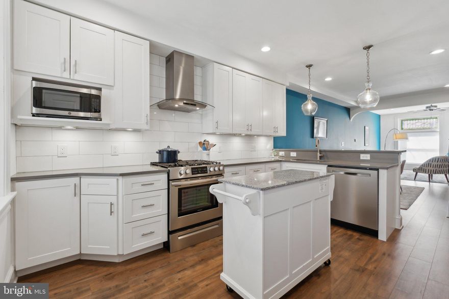 This beautifully maintained townhome in Brewer’s Hill offers 3 bedrooms and 3 bathrooms across over 1,900 square feet of thoughtfully designed living space. Historic charm meets modern updates, with stained glass accents above the front door and living room, exposed brick walls, and soaring 9-foot ceilings. The house also includes 5 more years of the CHAP tax credit. A HUGE savings in property taxes!

The open-concept main level seamlessly connects the living, dining, and kitchen areas, creating an inviting space for both everyday living and entertaining. A gourmet kitchen anchors the space, featuring gleaming quartz countertops, a spacious breakfast bar, and stylish pendant lighting. Stainless steel appliances, a gas range, and an exhaust hood enhance both form and function, while ample cabinetry provides generous storage. Natural light fills the space, creating a bright and airy atmosphere.

From the kitchen, step outside to a partially covered parking pad with alley access. In the basement you will find a fully finished lower level. This level includes a versatile bonus area, a full bathroom, and a bedroom—ideal for guests, a home office, or additional living space.

Upstairs, you will find the primary and secondary bedrooms as well as the en-suite bathroom and hallway bathroom. The primary suite includes two large closets with built-in shelving and an en-suite bathroom with a dual vanity and large walk-in shower with built-in bench. The second bedroom includes plenty of storage with two closets and tons of natural light. The hallway bathroom has a full size tub. The laundry is also located on the main bedroom level for added convenience.

A glass door from the hallway leads to a stairway up to the rooftop deck—one of the few homes on this block to offer this feature. With stunning views, it’s the perfect space for relaxing or entertaining.
Located in Brewer’s Hill, this home is surrounded by a dynamic mix of historic charm and modern conveniences. Once home to Baltimore’s iconic brewing industry, the neighborhood now boasts a thriving scene of modern conveniences such as The Shops at Canton Crossing, a diverse set of restaurants, and breweries such as Mobtown Brewing Company.

Additional highlights include 5 years of remaining CHAP tax credits (important to mention twice, lol) and an 8-year warranty on the rubber roof installed in 2020. Don't miss this opportunity to own a piece of Brewer’s Hill history with modern updates and exceptional features.