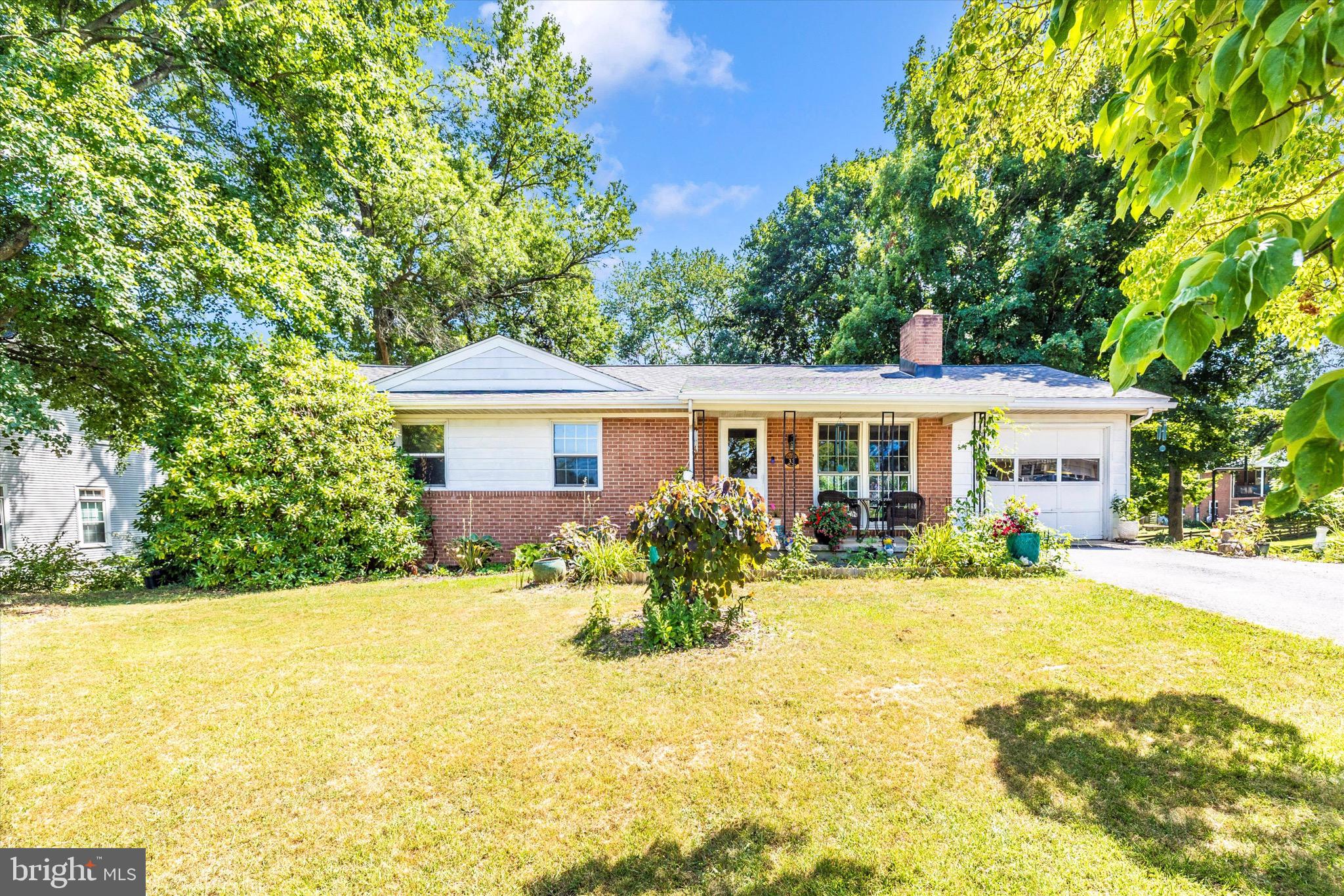 Imagine, your own little homestead! A rare opportunity, this lovely all brick rancher provides ample space for living and enjoying outdoor hobbies such as gardening and raising chickens! It's also USDA eligible which mean 0% down! In a neighborhood off the main road in the charming town of Myersville, you have the luxury of public amenities with the flexibility of no HOA! Owner has taken care to update bathrooms, repaint, refinish the stunning oak hardwood floors and added a brand new roof in May 2025.
Enter into the living space with wood fireplace and bright natural light from the large windows! The living area flows into the dining area, where the garage entry is. Kitchen is cleverly spaced, with butcher block work space, cabinetry, built in pantry, and stainless steel appliances. Main level provides 3 bedrooms, including a true primary suite with a private bathroom. One full bathroom in the hallway completes the main level.
Basement can be accessed from inside by the kitchen or outside, as it is a full walkout! A large space for gathering, hobbies, gaming, playing, the possibilities are endless. A fireplace downstairs also brings a cozy feel. A office/den room and a true bedroom finish off the basement! Large unfinished storage and utility area could hold canning, holiday decor etc. The backyard is expansive, with space for entertaining, gardening, chickens - potential abounds!
