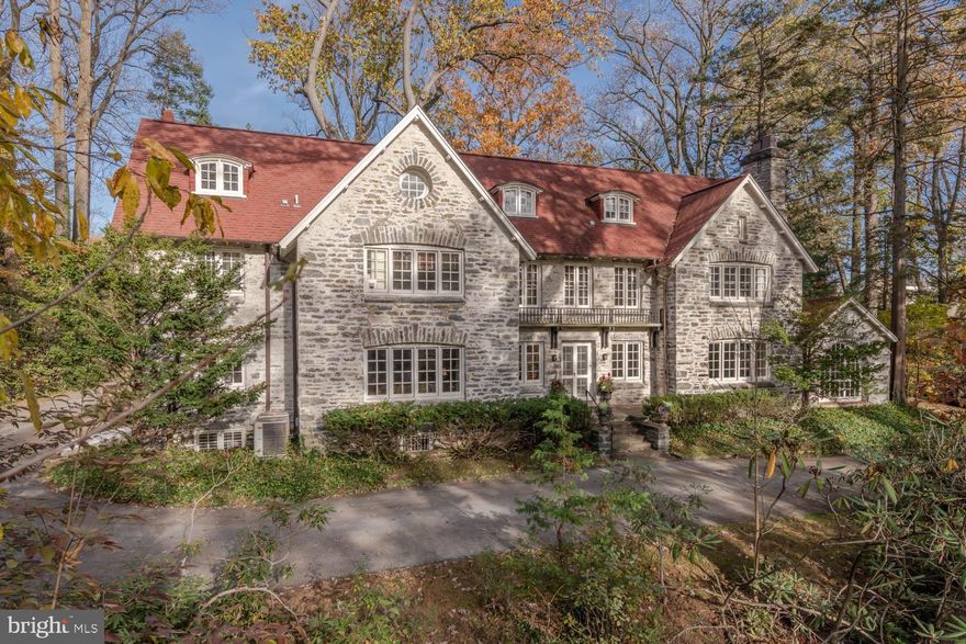 Come visit this magical Main Line farmhouse estate and you'll never want to leave! This oasis will afford your family a unique, irresistible mix of privacy and exclusivity, with easy access to shopping, restaurants, schools and Center City. It's hard not to fall in love with the dramatic setting on enchanting Wister Road, a hidden-away street with only two houses and virtually no car traffic. Peace and serenity are yours on 2.2 acres of lovely landscaped grounds with a creek running through; yet you're just a half mile from Suburban Square and everything else you need. What a rare offering! Down a tranquil rhododendron-lined meandering driveway awaits a stunning stone home with lots of history and love put into it. Built in 1909 and extensively updated by the current owners of 20+ years, is both an architectural gem and a comfortable place to live. Numerous updates were thoughtfully completed over the years. On the exterior, these include architectural roof shingles; a repaved driveway with new stone pillars, lighting and stone apron; and a redesign/rebuild of the rear outdoor patio with new stone wall, stairs and lighting, blending original brick of the house and new flagstone. Inside is as impressive, with extensive renovations done in the kitchen, pantry, library, bathrooms, laundry room and basement; the addition of a first floor sky-lit hall, mudroom and powder room; radiant heat flooring in several areas; updated electrical with new panels; and central air. As importantly, the residence has beautiful bones, structure and flow, with all the modern comforts you want. There's no better house to entertain in, with wonderful nooks for private conversations and grand spaces for large crowds to convene. Relax or host guests in the formal dining room, living room, glorious sunroom with heat, faux painted walls and new carpeting, and elegant library/TV room with wood paneling brought in from a 1740s Connecticut farmhouse. The butler's pantry with original built-in cabinetry and well-appointed chef's kitchen feature striking wide-plank pine floors relocated from an early 1900s whiskey bar in Maryland. Even the sun-filled kitchen, hall, mudroom and first floor powder room have radiant heat to warm your feet! In summer, hang-out on the fabulous back patio overlooking the sprawling yard where you can cook/gather with friends and family. When it's time to unwind, take either of two staircases to the sleeping quarters. The second floor offers four generous bedrooms (including the enormous en-suite master with three different window views), three baths and laundry room, and the third floor presents another four  bedrooms (two now used as offices) and a full bath. Enhancing the lifestyle is a partial-finished full basement with new carpet and a powder room, and a detached two-car garage with an apartment that can be renovated above. From the exquisite details and irresistible charm to the contemporary finishes and convenient locale, this home is truly one of a kind.