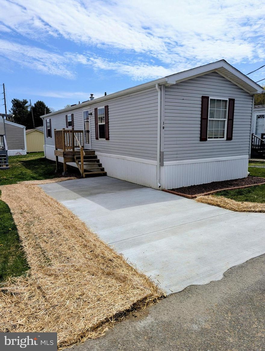 Welcome to 19 Woodland Lane, a well-maintained 2001 Castle Manufactured Home located in the Woodland Mobile Home Park in Mertztown, PA. This recently updated residence features 2 bedrooms, 1 full bathroom, and 728 square feet of living space, offering an affordable and comfortable lifestyle in the Brandywine Heights Area School District. Inside, you’ll find upgraded laminate flooring throughout, a freshly updated kitchen with quartz countertops, refinished cabinetry, and an eat-in dining area. The full bathroom includes a modern vanity with quartz surface, updated fixtures, and a tub/shower combination. The bright living room offers a cozy and inviting space to unwind, and the laundry area behind the kitchen. This home is equipped with central air conditioning, electric heat pump, and is situated on a leased lot with a monthly fee that includes water, sewer, and trash services. Enjoy off-street parking and a location near local amenities, parks, and commuter routes. Whether you're searching for a low-maintenance primary residence or a cost-effective housing solution this is a great option for you.  Please note this is a MANUFACTURED HOME ON LEASED LAND and cannot be financed with traditional loan products.  This is a CHATTEL loan only.  Utility fee per occupant is $50 per month and includes water, sewer, and trash.  Lot Rent is $500 per month.