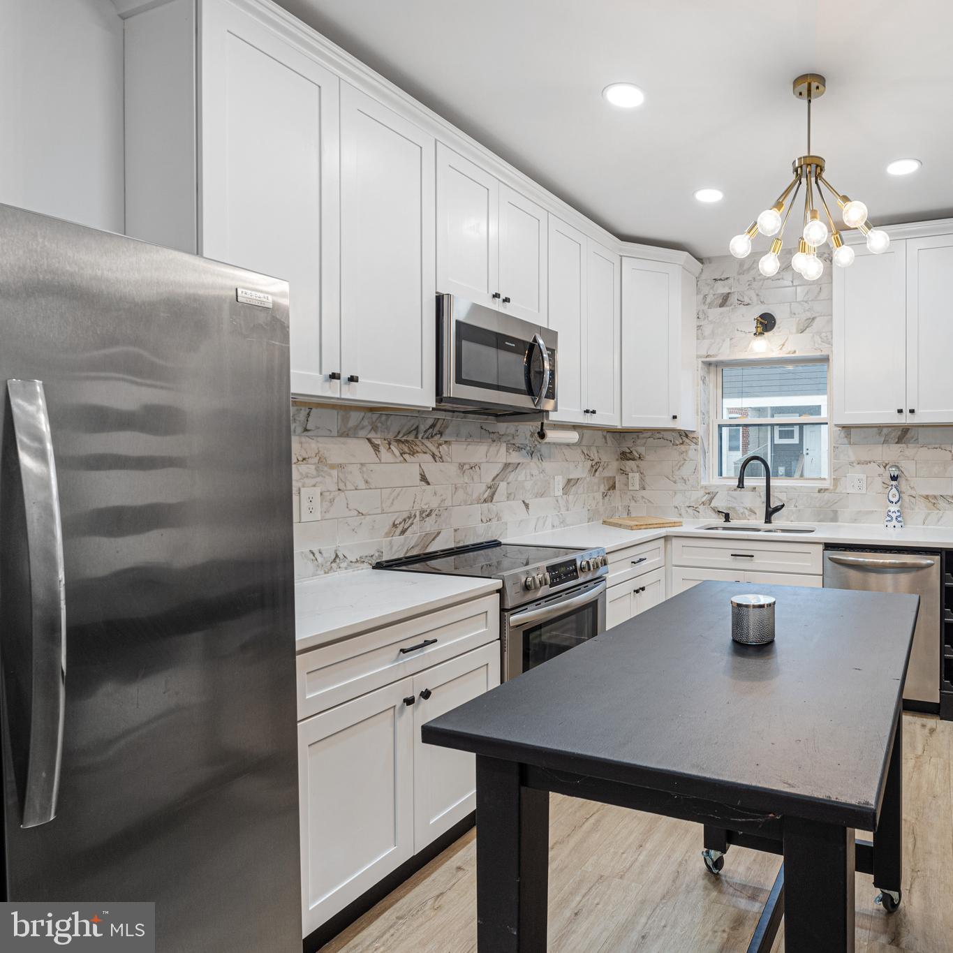 PRICE REDUCTION!!! Welcome to your dream home in the heart of Canton, just one block south of Patterson Park and minutes to the Waterfront!
This FULLY renovated 3-bedroom, 3 FULL bathroom townhome offers the perfect blend of modern upgrades and urban charm, complete with a private off-street parking pad in the rear and diagonal parking out front for added convenience.
Renovated from top to bottom in 2023, this home features all-new systems and finishes, including:
-Freshly painted throughout
-200-amp electrical service
-Recessed lighting throughout
-New furnace & water heater
-New rubber roof
-Interior & Exterior main sewer line replacement
-Luxury vinyl plank flooring throughout
-Three stunning full bathrooms with high-end finishes
Step inside to an open-concept main level with recessed lighting throughout, a living room featuring a cozy LED fireplace, spacious dining room and a kitchen with gorgeous quartz countertops, tiled backsplash, shaker cabinets, stainless steel appliances, pantry, and a convenient stackable washer.
Upstairs, you'll find two spacious bedrooms, including a luxurious en suite primary bedroom with an LED mirror, walk-in shower, bench seating, and access to a private balcony-the perfect place to enjoy your morning coffee. The second bedroom and an additional full bathroom with modern finishes rounds out the upper level.
The fully finished lower level complete with recessed lighting and new flooring includes a third bedroom, a third full bathroom with a tiled stand up shower, plenty of extra storage space, the utility room and provides access to the rear.
For added piece of mind A ONE YEAR First American Home Warranty is included with a Full-Price offer. With top-to-bottom upgrades, thoughtful design, and a location that can’t be beat-this home truly has it all.