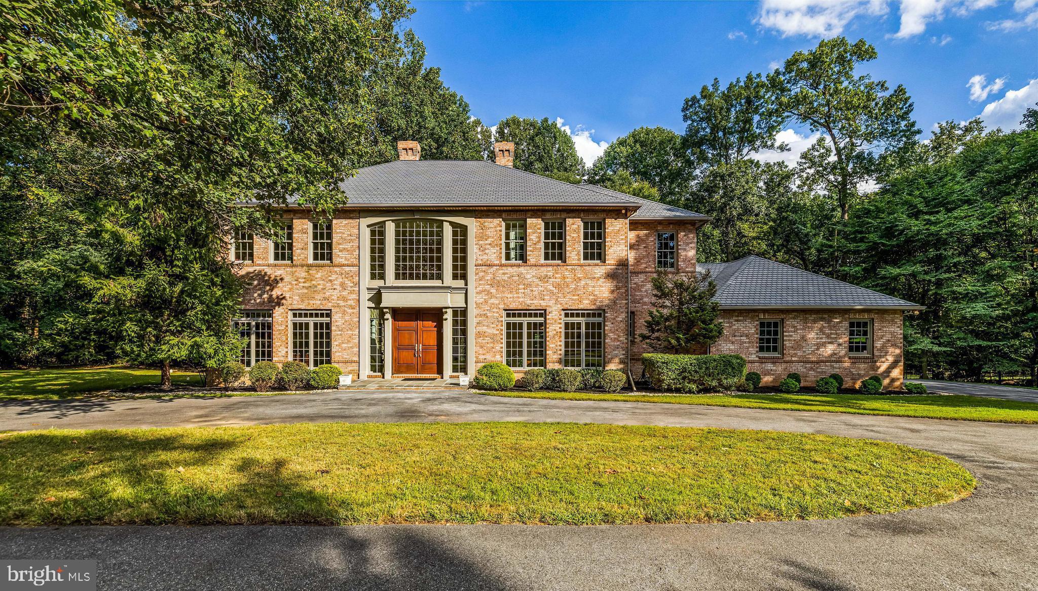 This statuesque all-brick Caves Forest Estates home is sited on one of the most private lots in the gated community at the end of the cul de sac. As you round the circular driveway, the first steps up the bluestone front porch to the impressive custom front doors reveal a splendid two-story foyer with a dramatic, sweeping staircase as the impressive focal point. An expansive great room lies beyond featuring a classy, coffered ceiling, wood burning fireplace, built-in entertainment/storage unit and offering room to accommodate versatile seating layouts. Spacious eat-in kitchen boasts granite countertops and beautiful custom cabinetry showcasing a built-in buffet peninsula, center island with breakfast bar and home center desk. The most accomplished chefs will love creating and entertaining in this space with the stainless steel high-end appliances and convenient butler pantry/dry bar. The main level also offers a formal study, perfect for handling your business from home, with gorgeous hardwood floors and double crown molding plus a convenient main level bedroom and full bath. Upstairs, the primary bedroom presents a 9-foot tray ceiling and cozy gas fireplace, a stunning travertine tiled primary bath with oversized stall shower, Jacuzzi tub for unwinding and double sink vanity plus walk-in closet. Three additional generously proportioned bedrooms sit down the upper level hallway as well as the recently renovated laundry room that now presents custom cabinetry including a built-in organizer/folding counter and drying rack, laundry sink and new Maytag washer & dryer. A special bonus...all closets feature custom built-in organizer systems! The entire lower level is ready for customization to meet your specific lifestyle needs and has a stone paver walkout to the rear yard. What amazing gatherings you can look forward to on the rear bluestone terrace! Enjoy the peaceful wooded view as you prepare your al fresco meals on the built-in gas grill while listening to your favorite tunes through the terrace speakers. The attached 3 car garage is perfect for car enthusiasts or added storage. This special property provides a peaceful respite, tranquil setting and the benefits of an exclusive gated community, all conveniently located to the McDonogh School and Garrison Forest School. Close proximity to several other private schools as well.