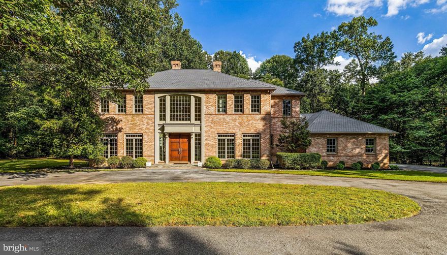This statuesque all-brick Caves Forest Estates home is sited on one of the most private lots in the gated community at the end of the cul de sac. As you round the circular driveway, the first steps up the bluestone front porch to the impressive custom front doors reveal a splendid two-story foyer with a dramatic, sweeping staircase as the impressive focal point. An expansive great room lies beyond featuring a classy, coffered ceiling, wood burning fireplace, built-in entertainment/storage unit and offering room to accommodate versatile seating layouts. Spacious eat-in kitchen boasts granite countertops and beautiful custom cabinetry showcasing a built-in buffet peninsula, center island with breakfast bar and home center desk. The most accomplished chefs will love creating and entertaining in this space with the stainless steel high-end appliances and convenient butler pantry/dry bar.  The main level also offers a formal study, perfect for handling your business from home, with gorgeous hardwood floors and double crown molding plus a convenient main level bedroom and full bath.  Upstairs, the primary bedroom presents a 9-foot tray ceiling and cozy gas fireplace, a stunning travertine tiled primary bath with oversized stall shower, Jacuzzi tub for unwinding and double sink vanity plus walk-in closet.  Three additional generously proportioned bedrooms sit down the upper level hallway as well as the recently renovated laundry room that now presents custom cabinetry including a built-in organizer/folding counter and drying rack, laundry sink and new Maytag washer & dryer. A special bonus...all closets feature custom built-in organizer systems!  The entire lower level is ready for customization to meet your specific lifestyle needs and has a stone paver walkout to the rear yard.  What amazing gatherings you can look forward to on the rear bluestone terrace! Enjoy the peaceful wooded view as you prepare your al fresco meals on the built-in gas grill while listening to your favorite tunes through the terrace speakers. The attached 3 car garage is perfect for car enthusiasts or added storage. This special property provides a peaceful respite, tranquil setting and the benefits of an exclusive gated community, all conveniently located to the McDonogh School and Garrison Forest School. Close proximity to several other private schools as well.