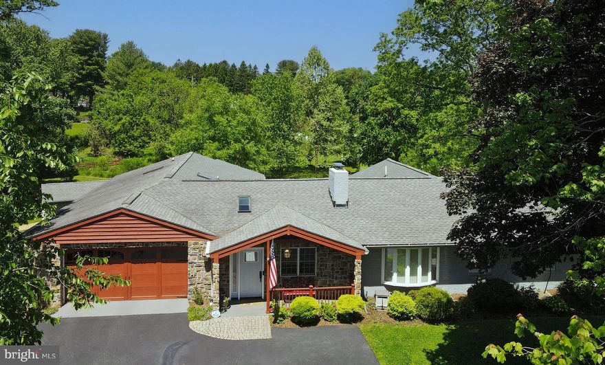 Tucked away in a quiet neighborhood on a captivating park-like 1-acre lot, this spacious home with lots of extras is sure to please. Close to it all but enjoys privacy, located on a NON-THRU Street overlooking open space in the front with a wooded view to the back. Thoughtful renovations include an improved floorplan and flow. 5 bedrooms and 3 full baths are all found on the first floor. Access to your own private porch with delightful views of the rear yard is accessed from the main bedroom. Right off of the main BR a sizeable exercise room leads to a handsome 15 x 30 composite deck. A flex space is currently used as a music room and is located adjacent to the dining room. The kitchen will inspire your inner chef, or it will make you look like one standing in it. Soft white dovetailed cabinetry with undermount lighting, LED recessed lights, and a rich navy-blue island with a curved Italian Carrera marble top seats 5. The island’s working side provides large drawer spaces for excellent storage, and it has a large capacity warming drawer with temperature control, and even built-in shelves on the island's end. Just beyond, a pair of navy-blue barn doors lends access to the pantry with built in shelf organizers - slide out baskets, a wine rack, and a stem glass organizer. Upgraded appliances include a Bosch microwave and oven suite. One wall oven is steam and the other convection. The focal point of the kitchen is the circular mosaic tile design over the cooktop, complete with a pot filler that you never knew you needed. Same applies to the touch faucet that helps make clean-up quicker. The kitchen adjoins the living room with crown molding, a generous sized wood burning fireplace, a beautiful granite hearth, and a custom live edge mantle. The family room, with a pass-thru to the kitchen, has a striking chevron marble faced LED fireplace with a granite mantle. Built-in cabinets for additional storage are located on either side of the FP with color matched shelving above. The volume ceilings are accented by grey shiplap with cedar wrapped faux beams. The family room also has direct access to the party sized deck and large picture windows overlooking the rear yard. A large addition was completed (contracted out by the current owners) on the left side of the home, has cathedral ceilings in much of the space. The unfinished portion of the basement, (great for storage), on the left side was also part of the addition. But wait there’s more - 2 additional bedrooms with proper egress windows are in the fully updated lower level, plus another full bath, rec room, additional laundry room and a kitchen with granite tops and a pantry area. Subfloors and original oak floors were replaced on the main floor with ¾” Brazilian cherry hardwood + some maple inlays were installed. The electric panel received a heavy up, to 400 AMP service for all of todays and future power needs. The incoming line to the house was buried underground. There are 2 zoned HVAC systems – 5 zones in total. An additional mini split is in the family room for added comfort. The front of the home enjoys sunrise views and sunset views to the back of the property. For added natural light, skylights were installed in the main floor foyer, laundry room, and addition side hall. The yard is a nature lovers dream with 50+ trees planted in the rear yard; many are flowering ornamentals. Low maintenance garden spaces attract a large variety of birds and butterflies. There is a bridge that crosses the babbling stream towards the rear portion of the property. Flood Insurance is only $414/yr. There is no HOA. Tax record is incorrect for square footage on main floor and basement.