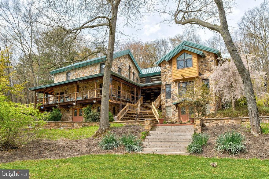 This original 1830's log cabin was built for the first manager of the Woolrich factory. Encapsulating the original structure are three 2 story post and beam-built additions, with beautiful stone exterior cultivated from the property.  Endless privacy and possibilities on almost 150 acres of pristine wooded land bordered by state game land with miles of trails to explore. Countless potential uses from family gatherings, hunting lodge, or any type of retreat, make this property outstanding. Now transformed into a magnificent living space, the property has maintained all of its original charm and character. The chef's kitchen showcases attention to detail and functionality with granite countertops, a variety of storage options, a wine cooler, beverage drawers, and a built-in bar area. The extensive living space offers versatile uses and comfortable living with 7 bedrooms, 5.5 bathrooms, various dens and offices, and copious room to entertain. The 3-story spiral staircase leading to a loft office/library adds an elegant touch to the design. Music, exercise, and family rooms in the walk-out finished lower levels provide space for all kinds of interests and hobbies. A separate structure houses the generator which insures all of your comforts are still in place, even if you were to go "off grid".  The fully insulated gothic style 40 x 70 Unadilla barn with 14 x 20 foot insulated overhead doors and utility garage provide ample space for pull-through vehicle/ RV storage and workshop activities. You will find a half bath and upstairs office space inside this building as well. The outdoor elements of the property also contribute to its allure, with professional landscaping, hardscaping, stone retaining walls, two circular driveways, and a brick patio creating an inviting environment for outdoor activities and entertainment. The wrap-around decking offers panoramic views of the surrounding woods and wildlife. Included on the property are a playhouse, outhouse, stone generator building, and gas tanks with pumps. This property embraces the natural beauty of the wooded acreage and offers a serene retreat away from the urban bustle.  This property has been maintained, updated, and loved by its current owner for decades, and is ready for a new chapter.