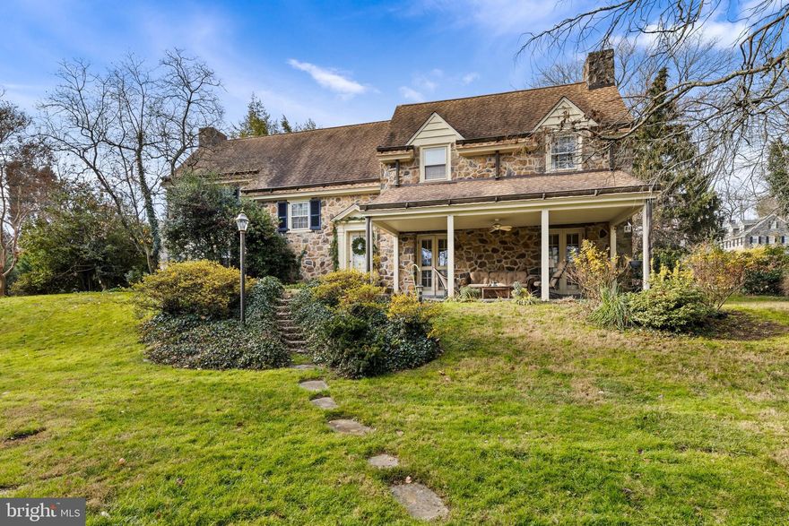 Don’t miss this gracious 1920’s Pennsylvania farmhouse colonial in sought-after South Wayne! Available for the first time in decades, this stone and frame colonial-style home provides a rare opportunity for buyers wanting a location walkable to train, schools, shopping, restaurants and parks. Guests are welcomed into a transverse Entrance Hall - a gracious space with built-in shelves, French doors and a classic staircase. The elegant step down Living Room has high ceilings, random width floors, built-in bookshelves and a fireplace.  4 sets of French doors lead to a covered porch in front & in the rear to a walled patio and a unique stone springhouse. The Dining Room – currently used as a family room – features a lovely built-in china closet, sconces and a dutch door to the side yard. A Butler’s Pantry with sink, cabinets and mini fridge is located between the sunny Family Room & the Kitchen. A Mudroom/Pantry area is located off the Kitchen as well as back stairs, access to the basement and to the rear yard.  Two powder rooms and several closets complete the first floor. Wood floors, extensive millwork, original hardware and built-ins are found throughout this lovely home. The 2nd floor offers a flexible floor plan with 4-5 light-filled bedrooms and 2 full plus 1 half baths. 3 of the 4 bedrooms have en suite access to bathrooms. There are two add’l rooms on the second floor, one currently used as a Den and the other a nursery/playroom. The 2 bonus rooms provide great space for buyers to reconfigure into larger closets or bathrooms. The sparkling half BA is brand new & has ample space for adding a tub or shower. In addition to a large unfinished basement (with egress stairs to the side yard) there is a walk-up 3rd floor attic offering great storage or potential living space. There is an attached garage and additional property to the left of the driveway. Mature perimeter plantings - flowering shrubs, perennials and specimen trees - provide privacy as well as scenic yearround views. All main floor rooms have doors to patios & porches, providing great light as well as flow for gracious indoor/outdoor entertaining.  The rear patio’s path leads to an Orchard Way side gate and mailbox. Wonderful location in one of the most popular neighborhoods in Radnor Township with easy access to the charming village of Wayne. Minutes to Chanticleer gardens, Wayne Art Center, and the Radnor Trail. Convenient to Center City, schools, universities, corporate centers, and the Airport.