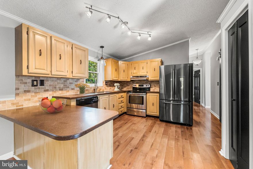 Priced To Sell Fast! Hot 2 Level Rambler with Finished Walk Out Basement, Spacious Kitchen with Stainless Steel Appliances, Tile Backsplash, Spacious Bedrooms, Hardwood Floors, New Custom Paint, Updates in Bathrooms, New Carpet, Wood Burning Stove, Patio, Much More!! Close to Schools, Shopping, and Commuter Routes.  This Will Not Last!