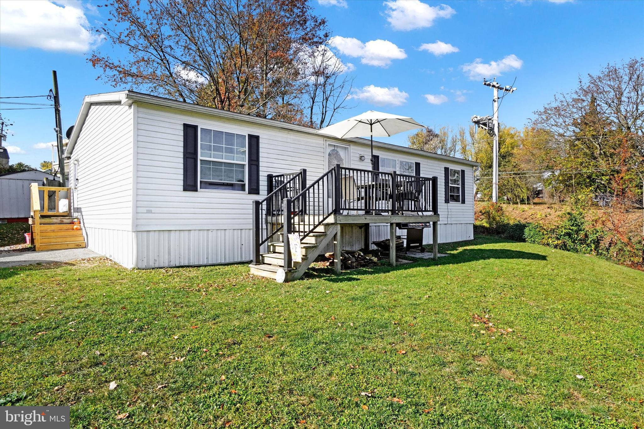 Welcome to your new cozy retreat! This charming 3-bedroom, 2-bath home offers a perfect blend of comfort and style. Step inside to find a spacious open floor plan, ideal for entertaining or just relaxing with family. The kitchen boasts plenty of counter space and an island-countertop, making meal prep a breeze. The main bedroom features an ensuite bath for your privacy, while the two additional bedrooms are perfect for guests or a home office. Enjoy sunny mornings on the front porch or host weekend barbecues in the yard. Located in a friendly community of Hilltop Acres, you'll have easy access to downtown Manheim, local amenities and parks. Lot rent is $570.00 per month. This property is not just a place to live; it's a place to call home! Come see it for yourself!
