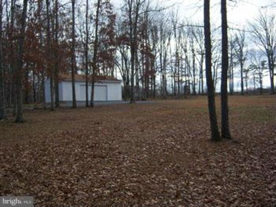 Beautiful 2.38 acre level building lot is cleared with grass lawn, lightly wooded, pastoral view. 24 x 36 garage built in 2007 including electric & finished gravel drive. Septic permit & camper trailer convey. Located between Winchester and Berkeley Springs for a easy commute.