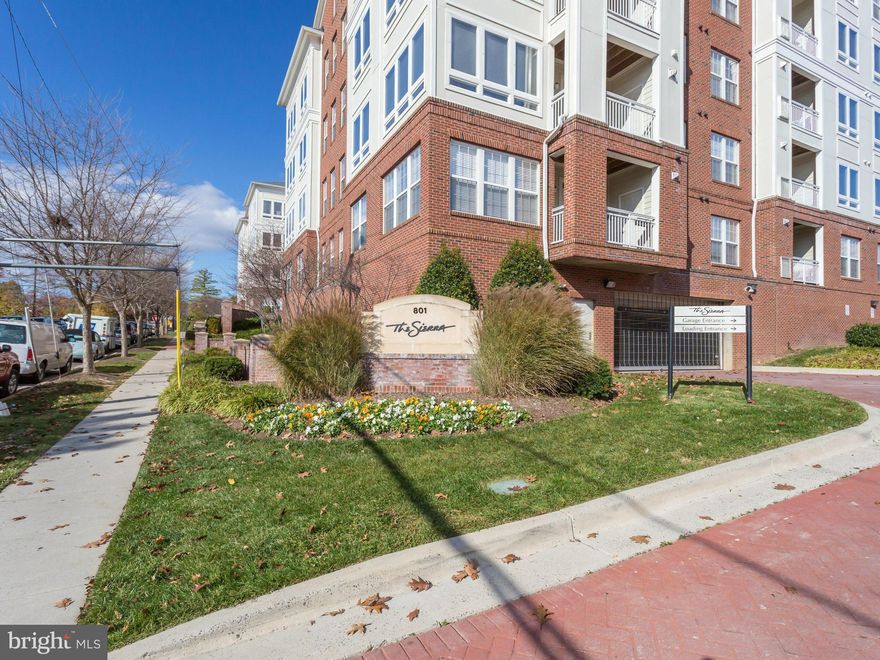 Bright, sunny condo (built 2005) w/2 master bedrooms -- ideal for roommates! Open layout with granite breakfast bar & SS appliances. Updated lighting & new hardwoods & carpet! Newer HVAC worth $9k! Deck overlooking 7th St. 1-car garage spot! Great amenities -- gym, concierge & water included. Stackable washer/dryer. Commuters dream: Access Rt 50, 66, Ballston, Rt 7, 395 & Shirlington!